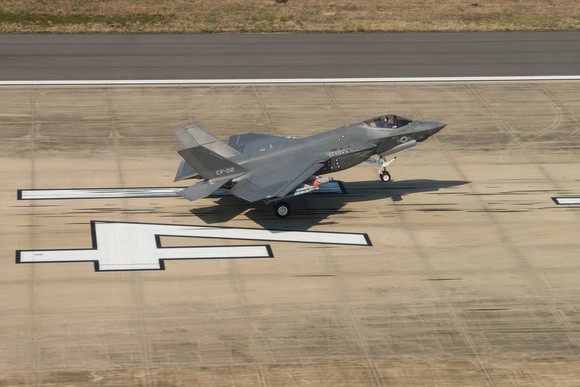 An F-35 lands on a runway.