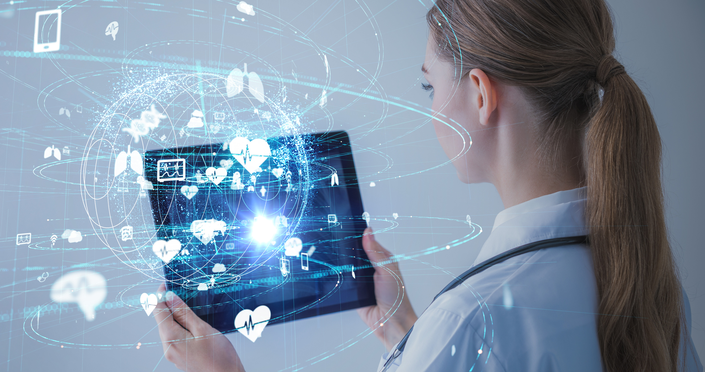 Female healthcare professional holding tablet with images of organs
