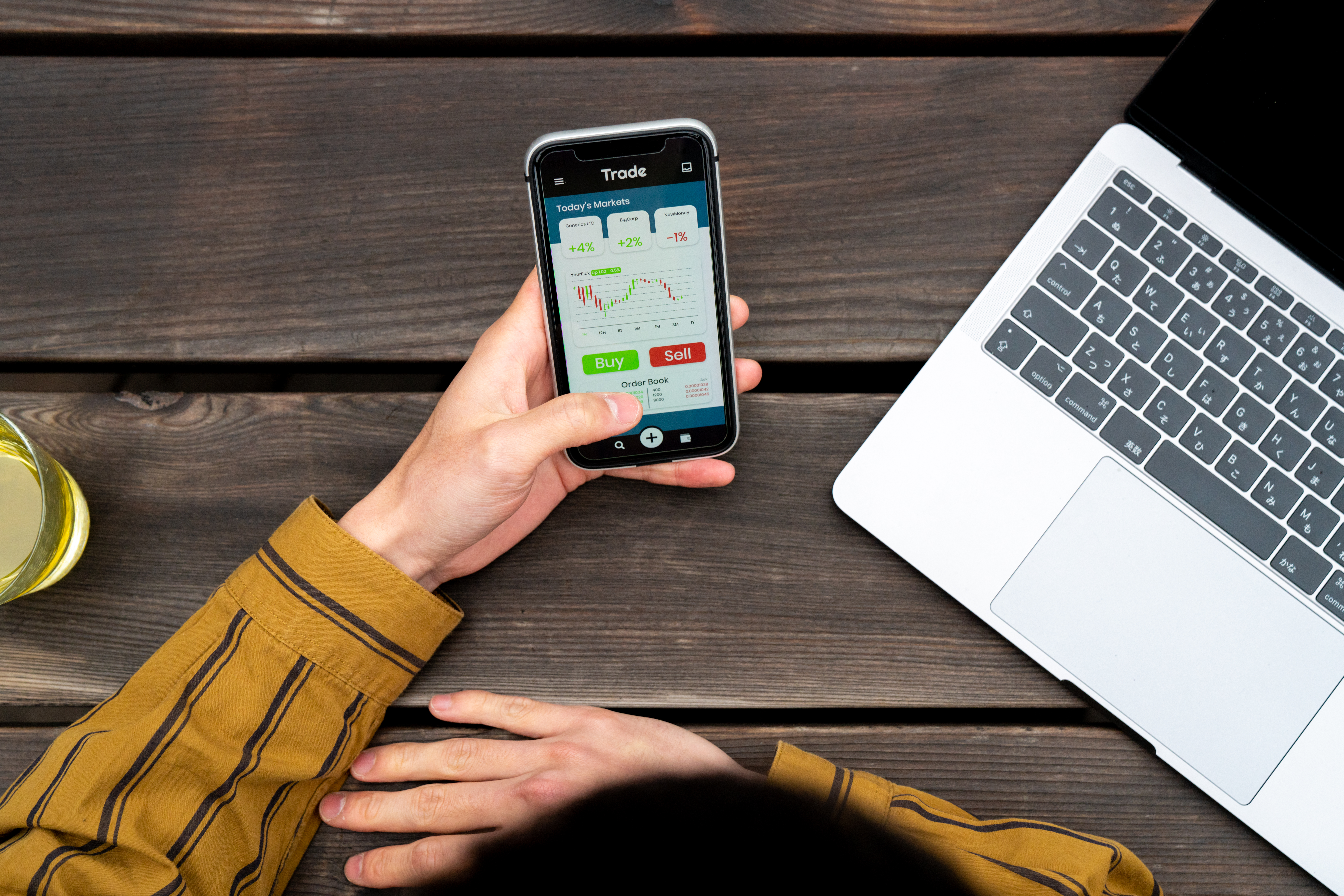 A person buys a stock on their phone