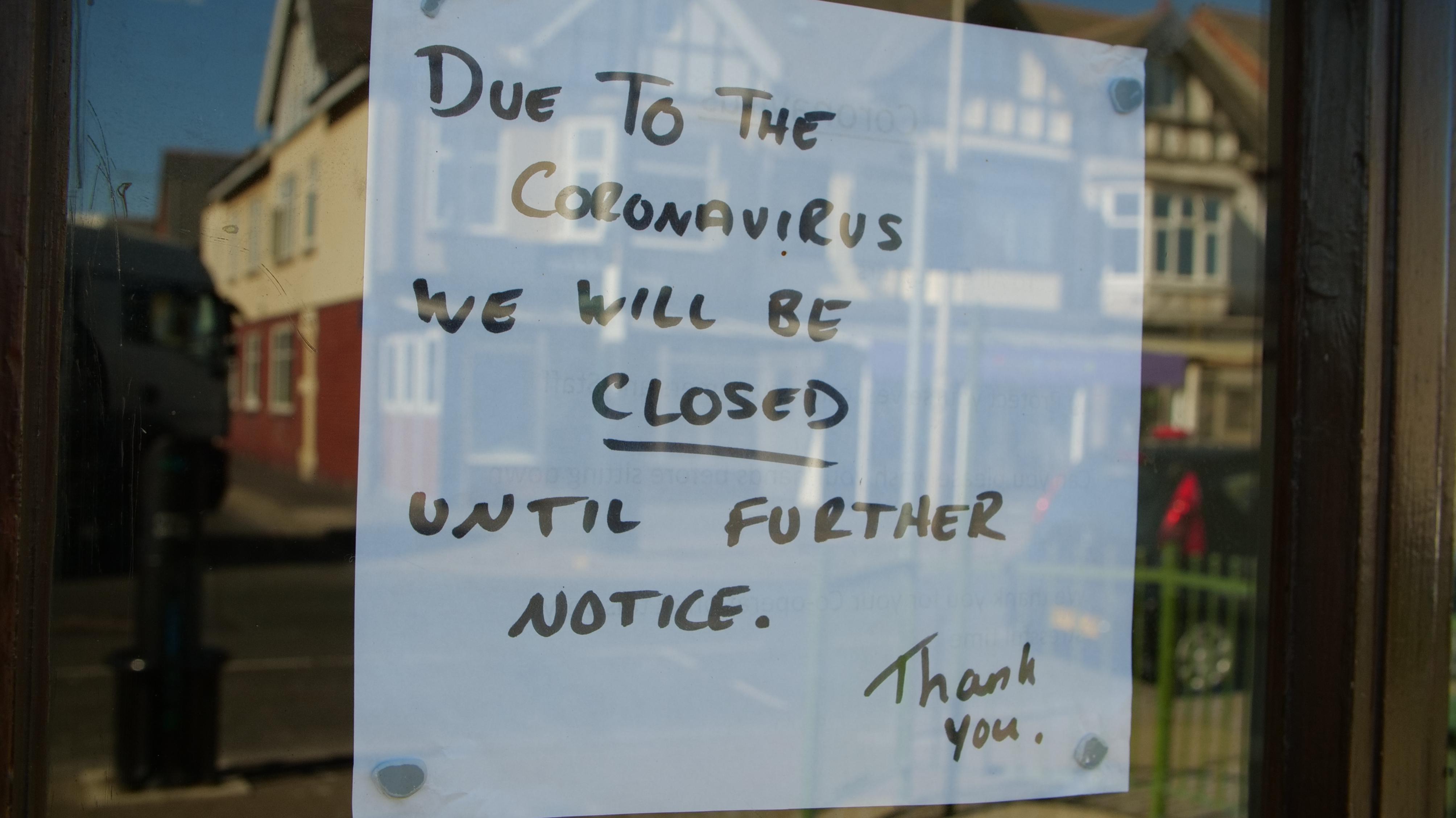 Business closed sign in a window.