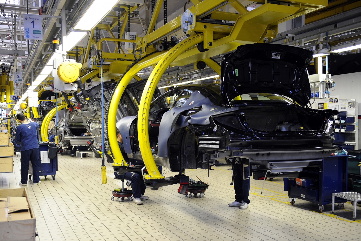Partially-assembled Maserati cars on a factory production line.