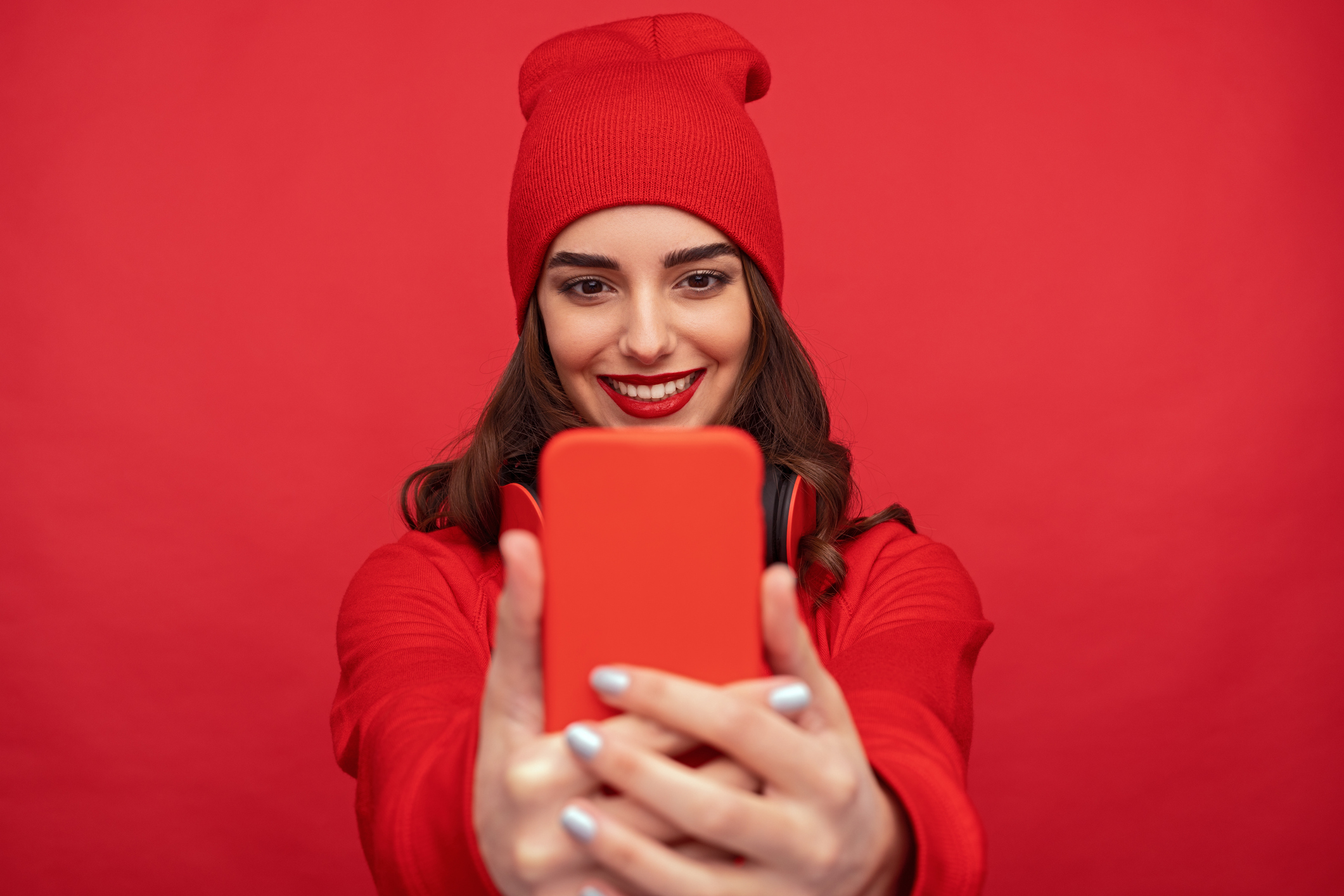 A young woman takes a selfie.