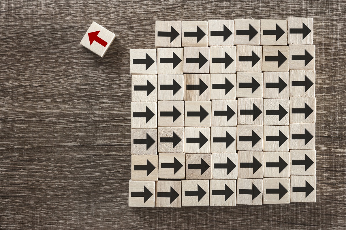 Red arrow on block pointing to the left while dozens of black arrows on blocks point right.
