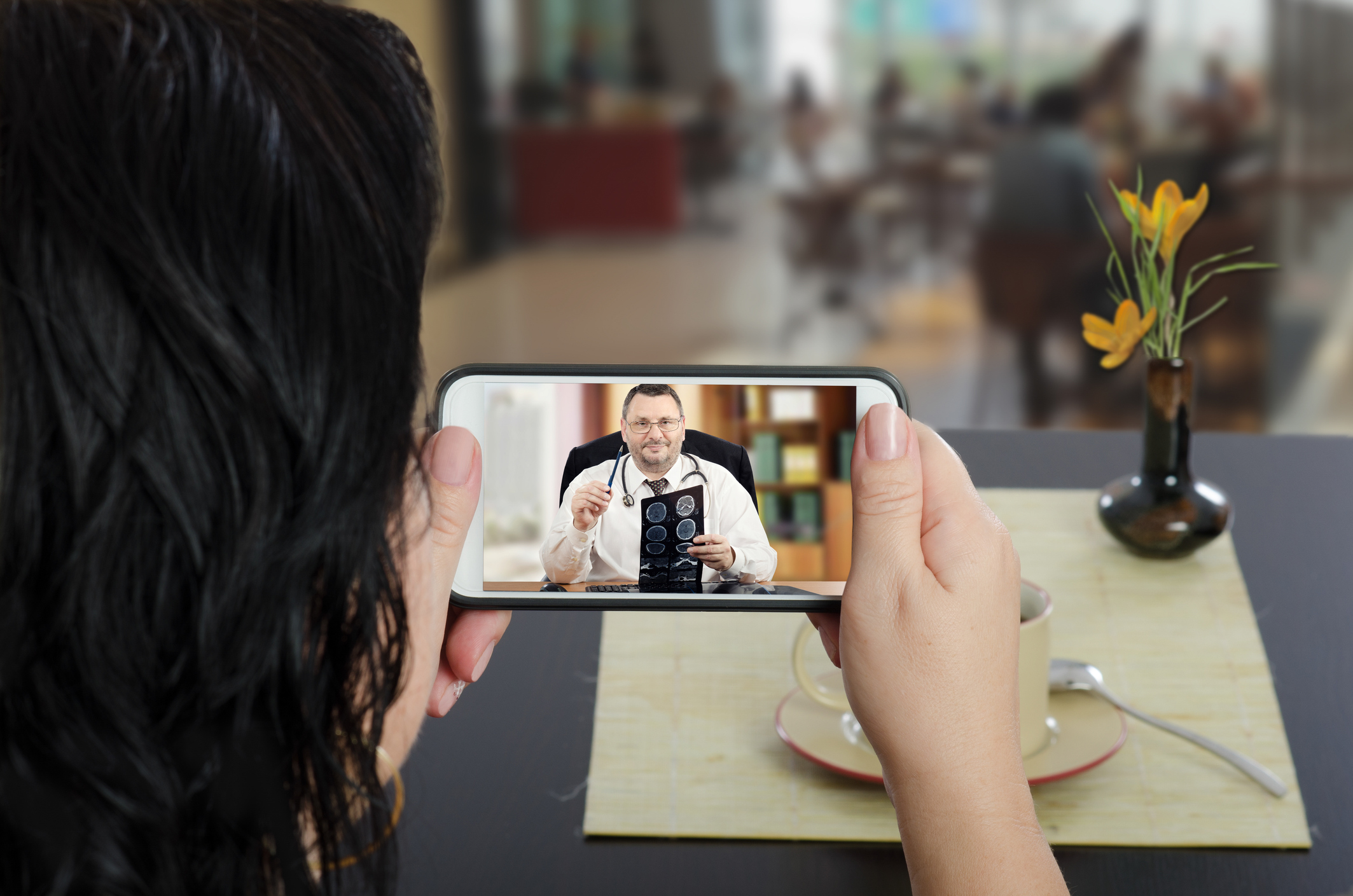 Woman video chatting with doctor on her phone