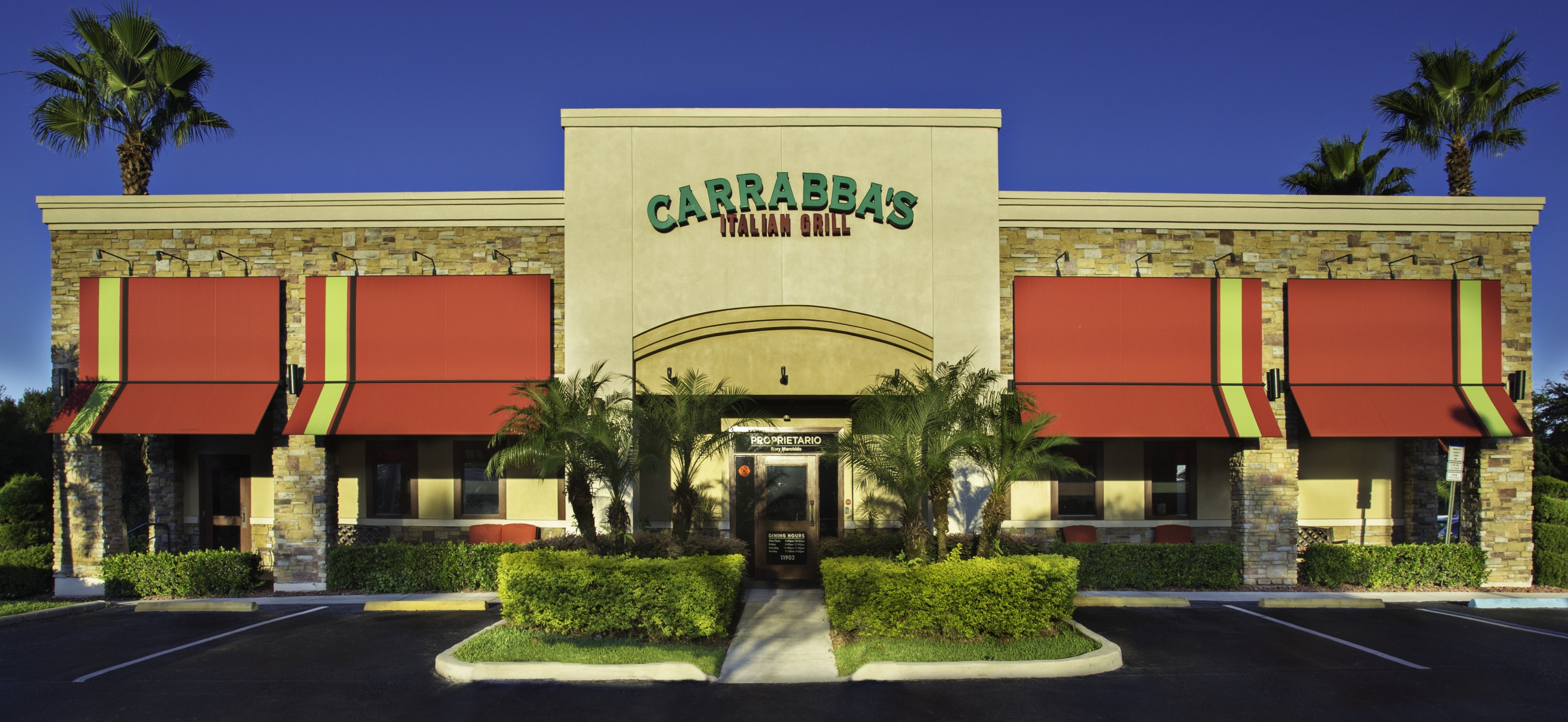 The sunlit exterior of a Carrabba's Italian Grill restaurant.