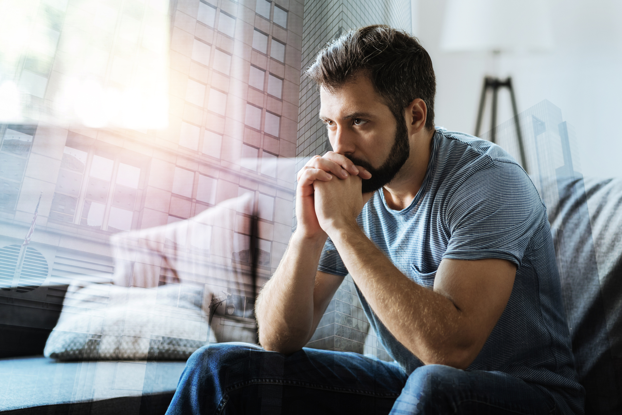 Man resting chin on hands with serious expression