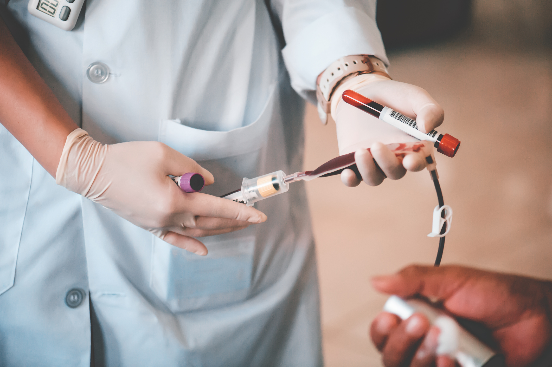 A nurse taking a blood donation from a donor.
