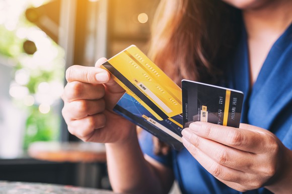 Woman with handful of credit cards
