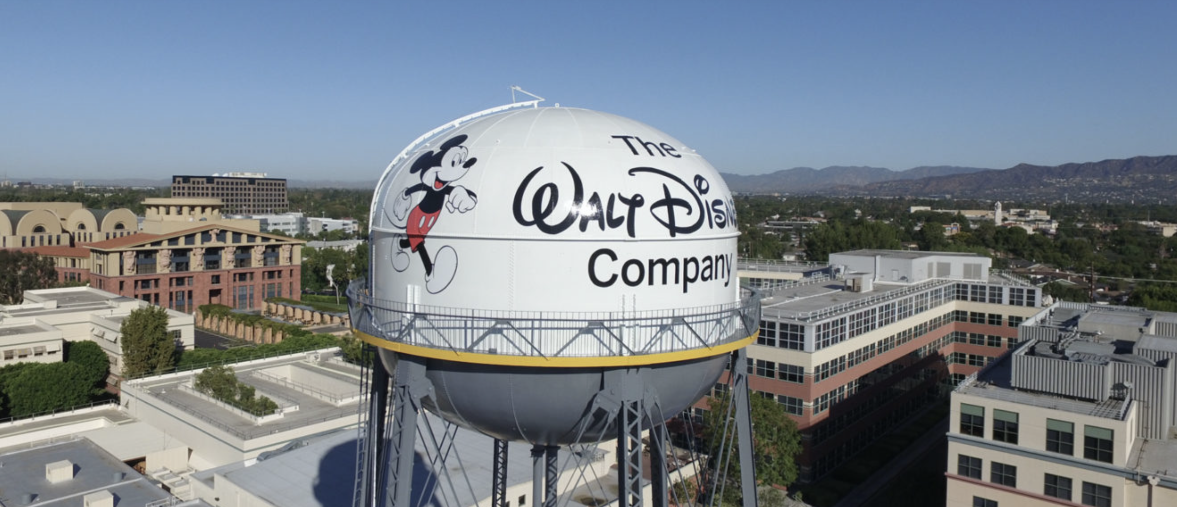 A tower at Disney studios with the image of Mickey Mouse and the Disney corporate logo printed on the side.