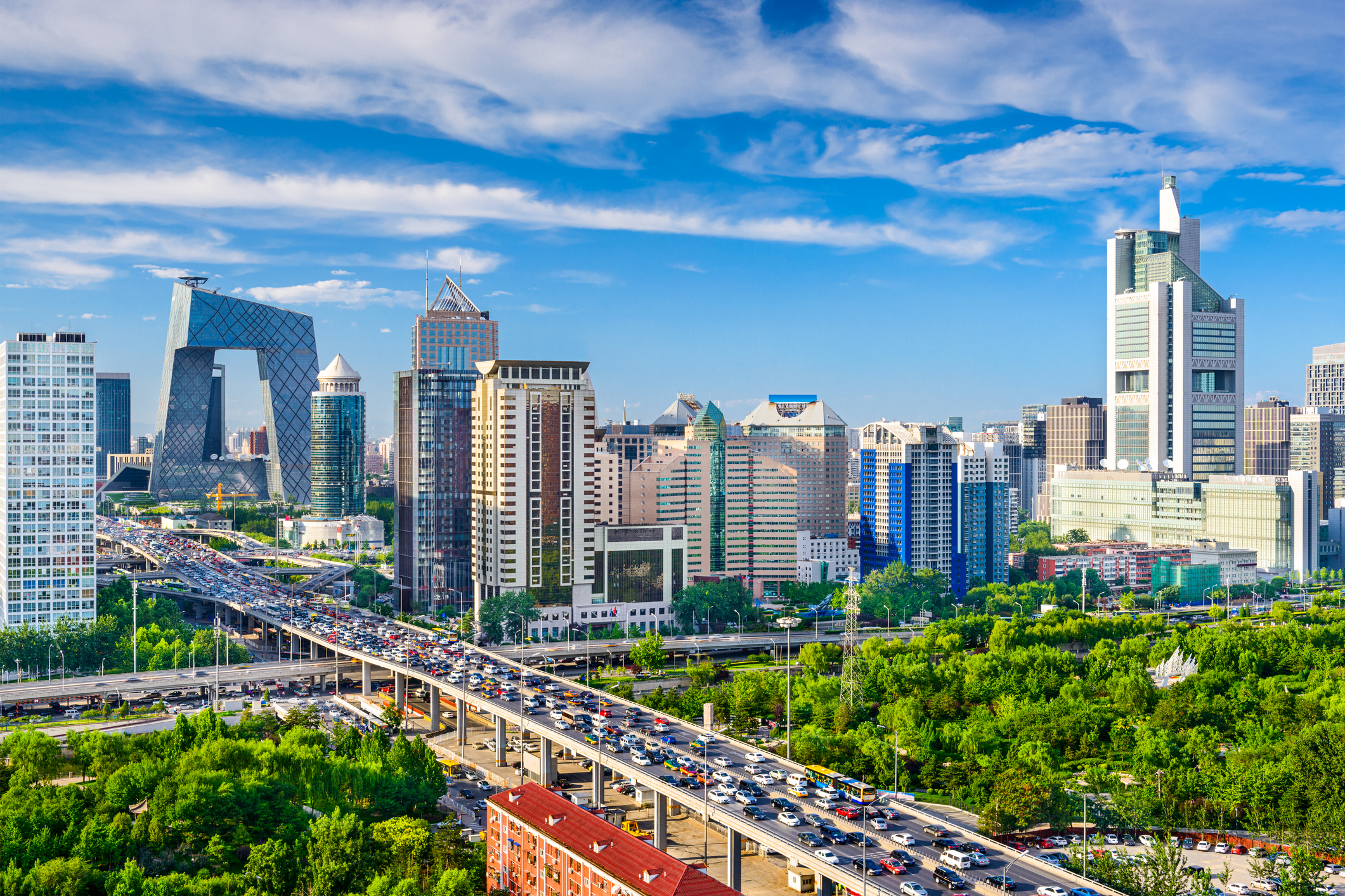 A view of the Beijing skyline from a distance on a clear, bright morning.