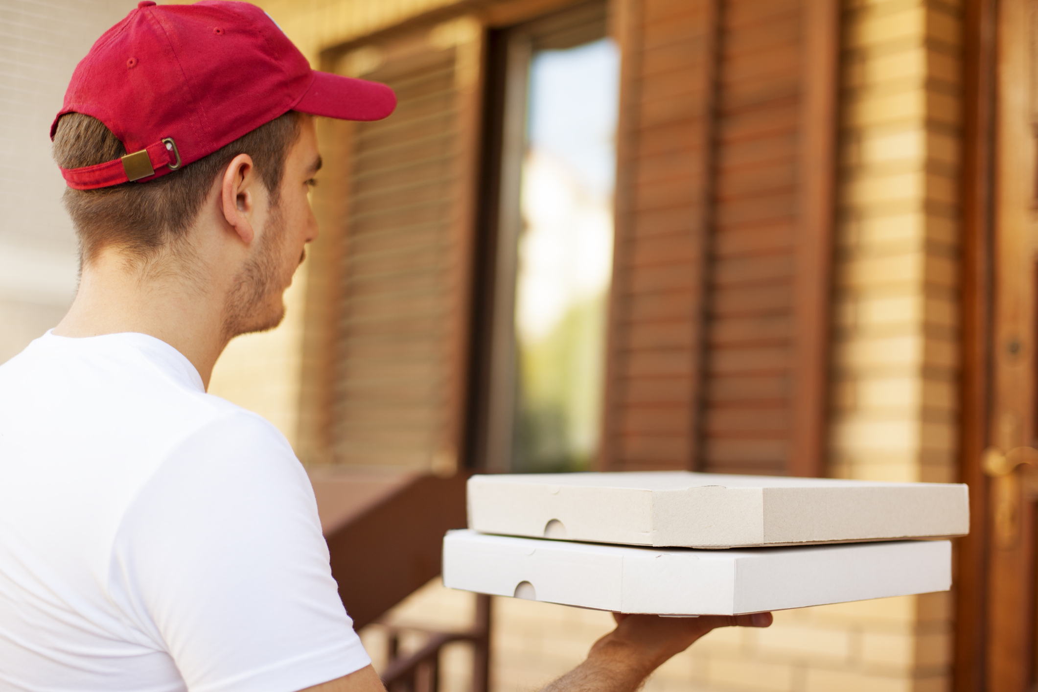 A person delivers two pizzas.