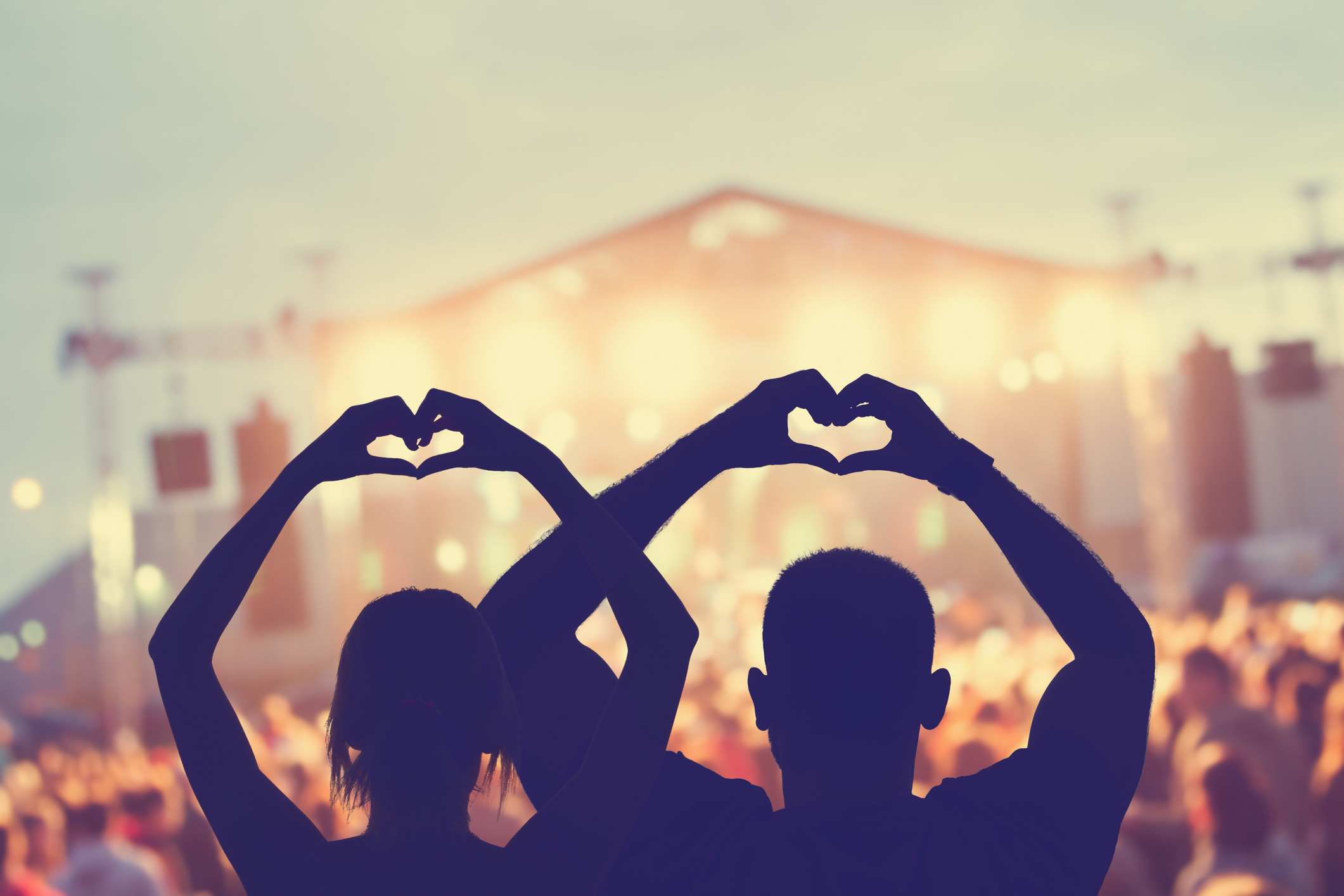 Concertgoers making heart sign with their hands