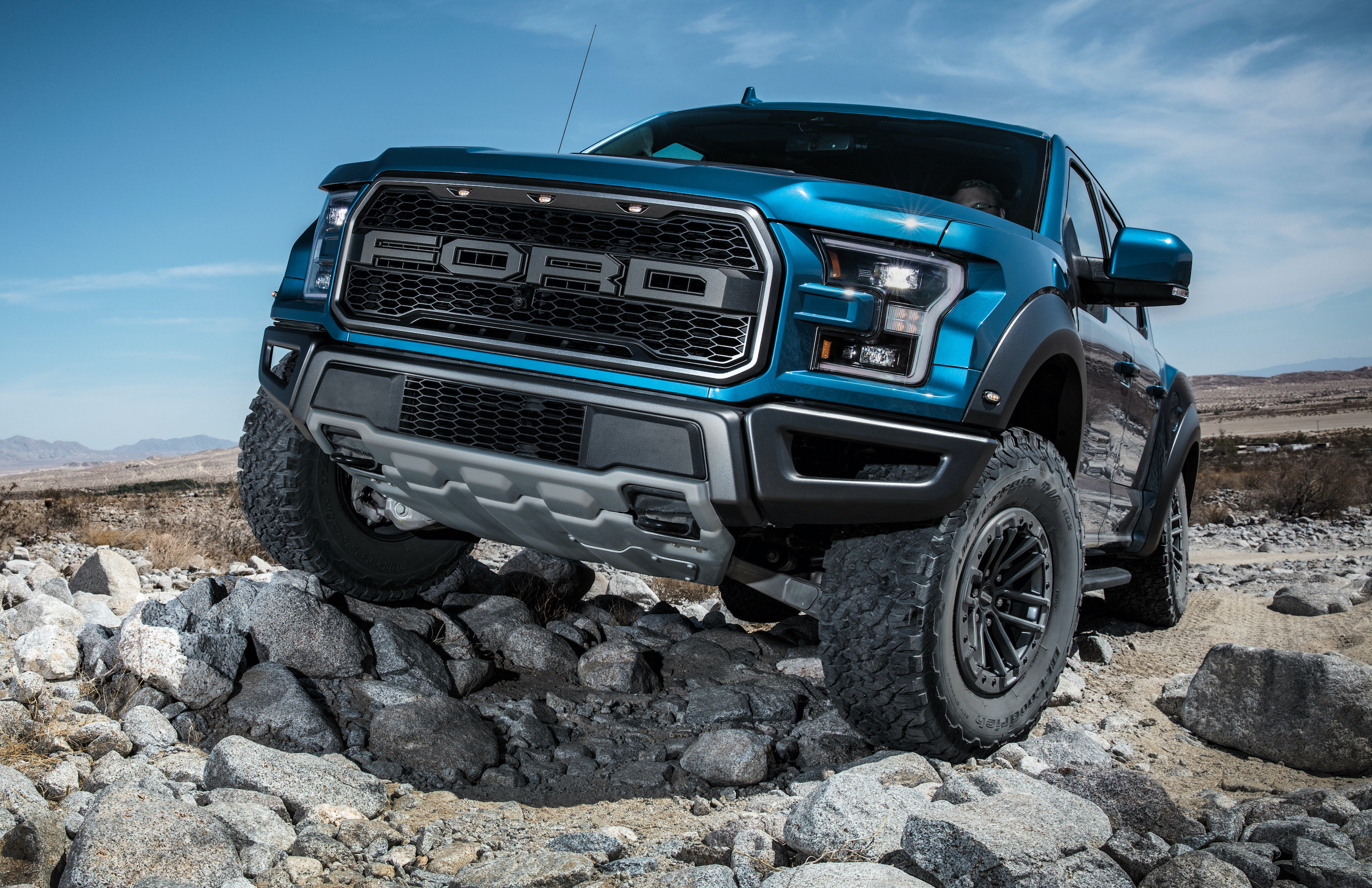 A 2020 Ford F-150 Raptor, a high-performance off-road pickup, shown on rocky terrain.
