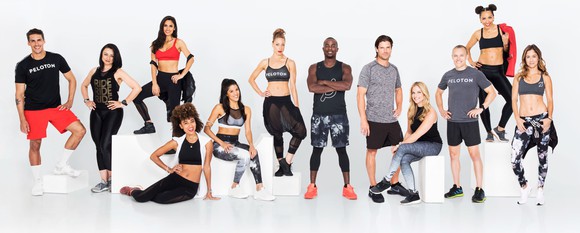 Peloton trainers pose in a group photo.