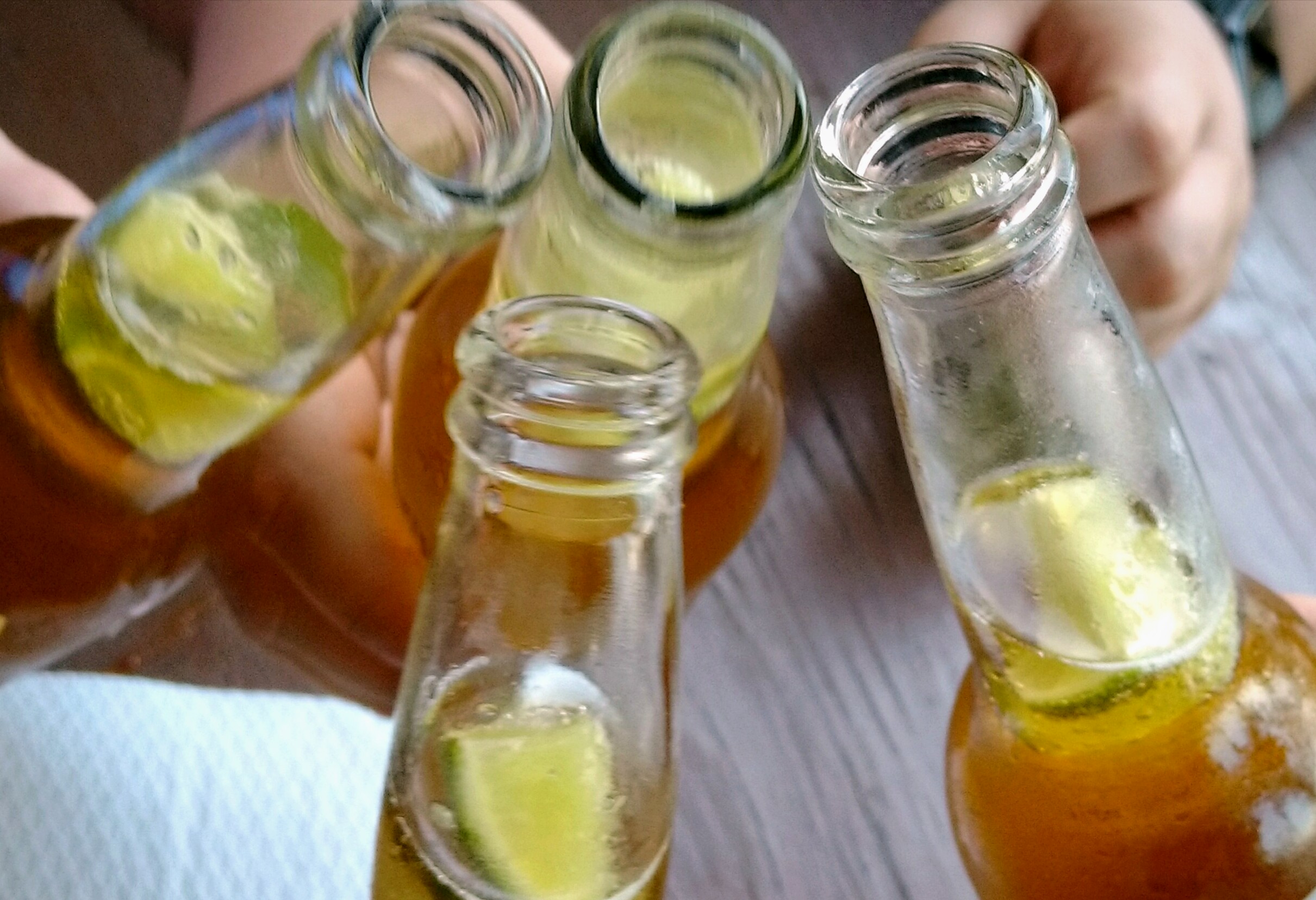 Bottles of beer with limes in the necks