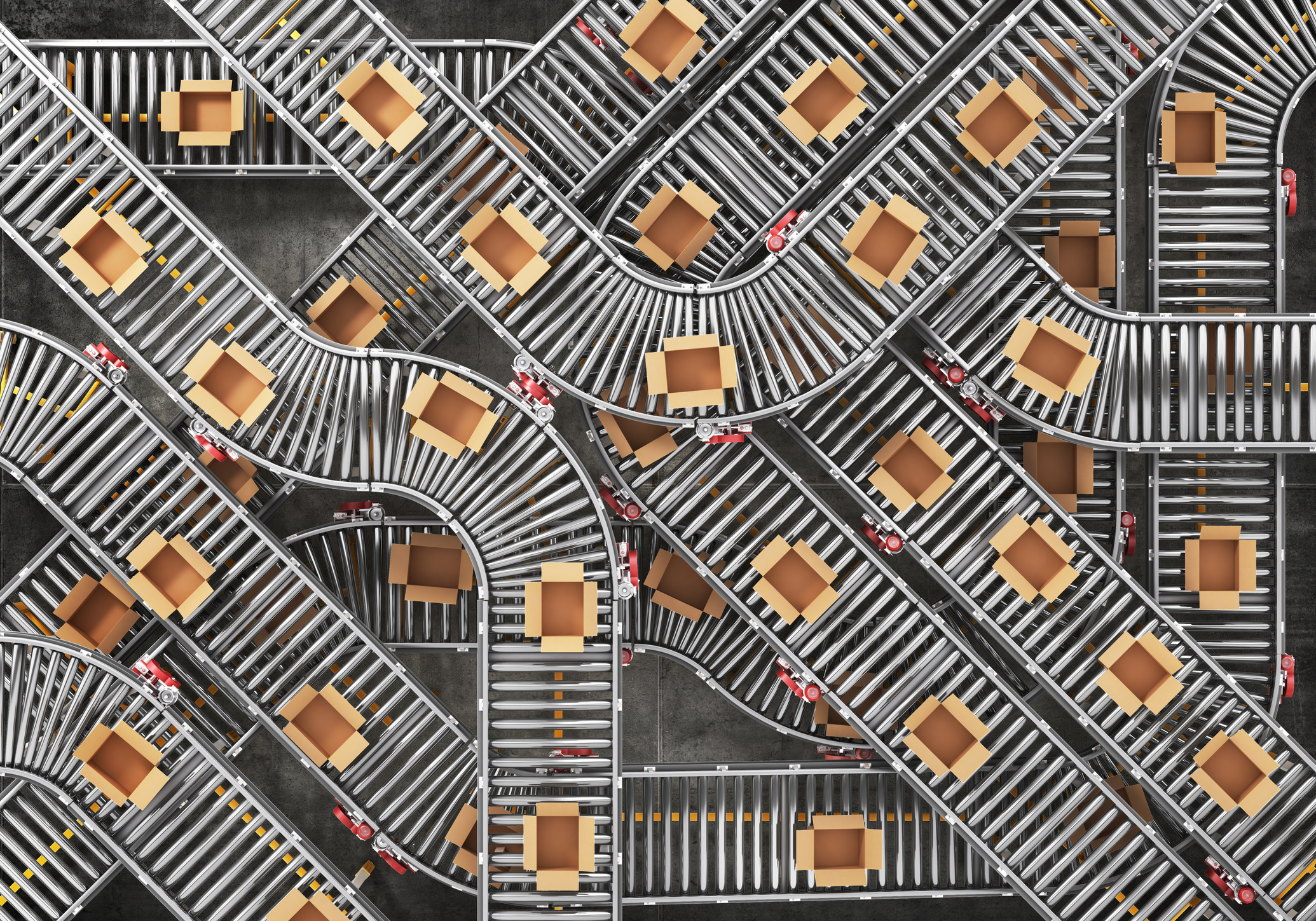 Network of conveyor belts carrying open empty boxes