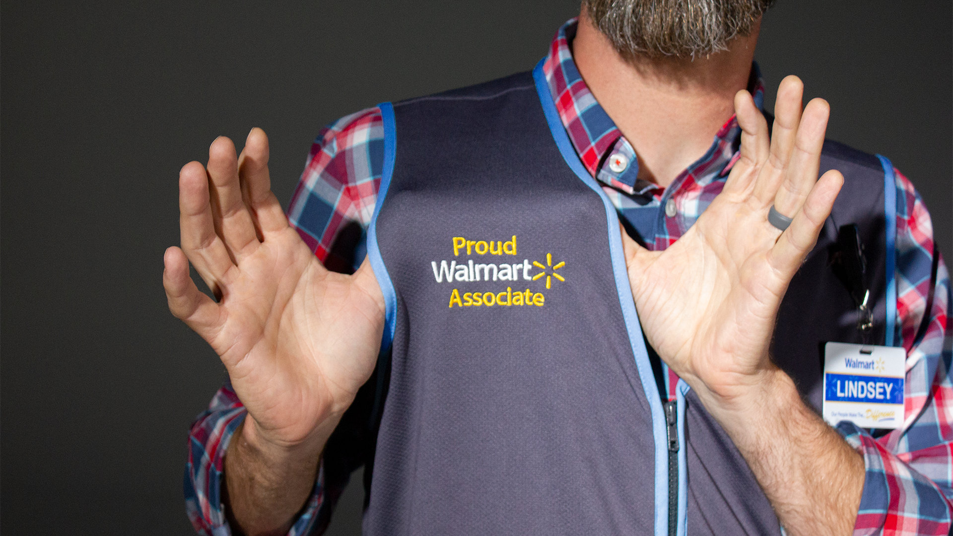 A Walmart worker displays his vest.