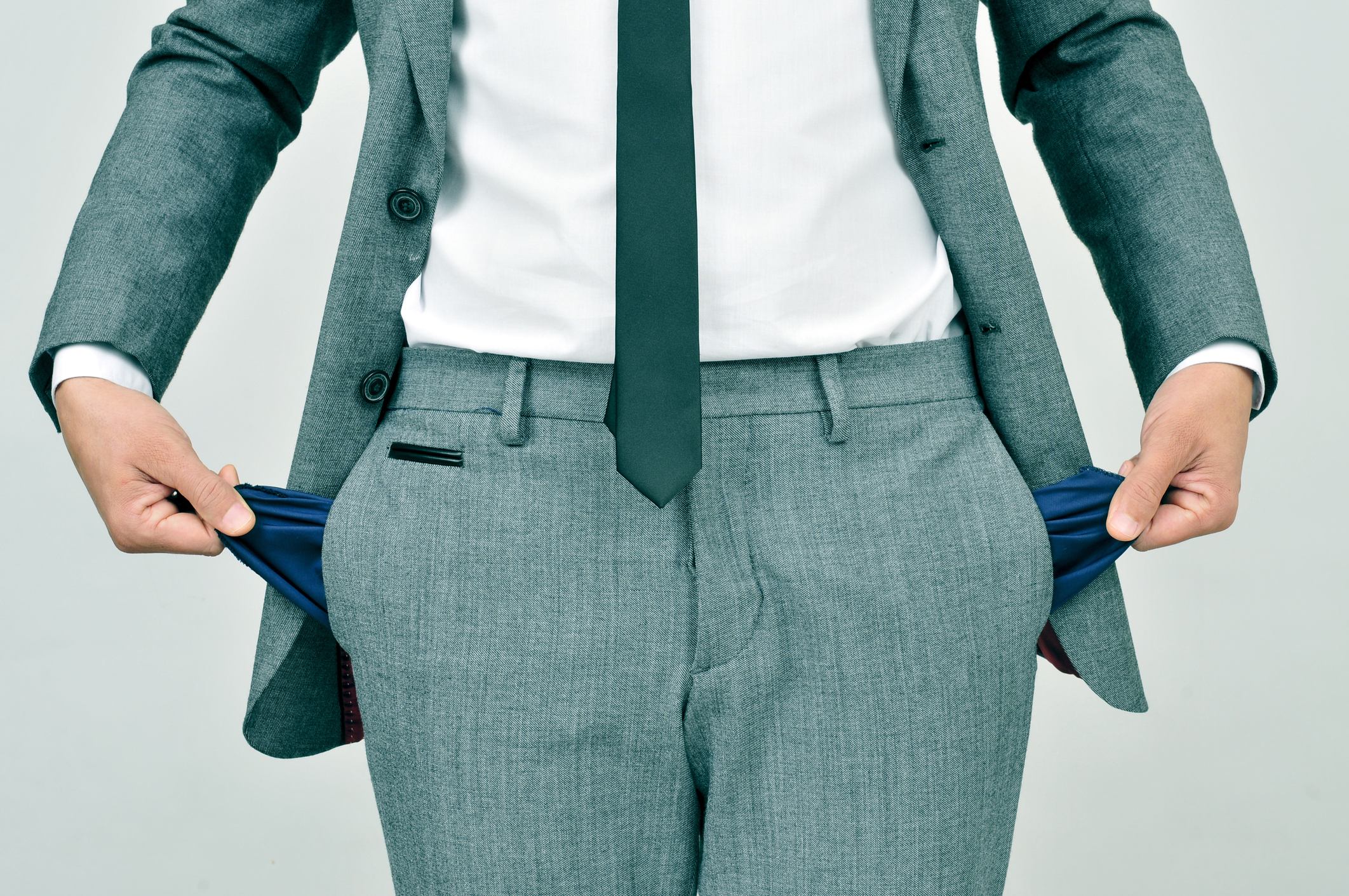 A man showing empty pockets.