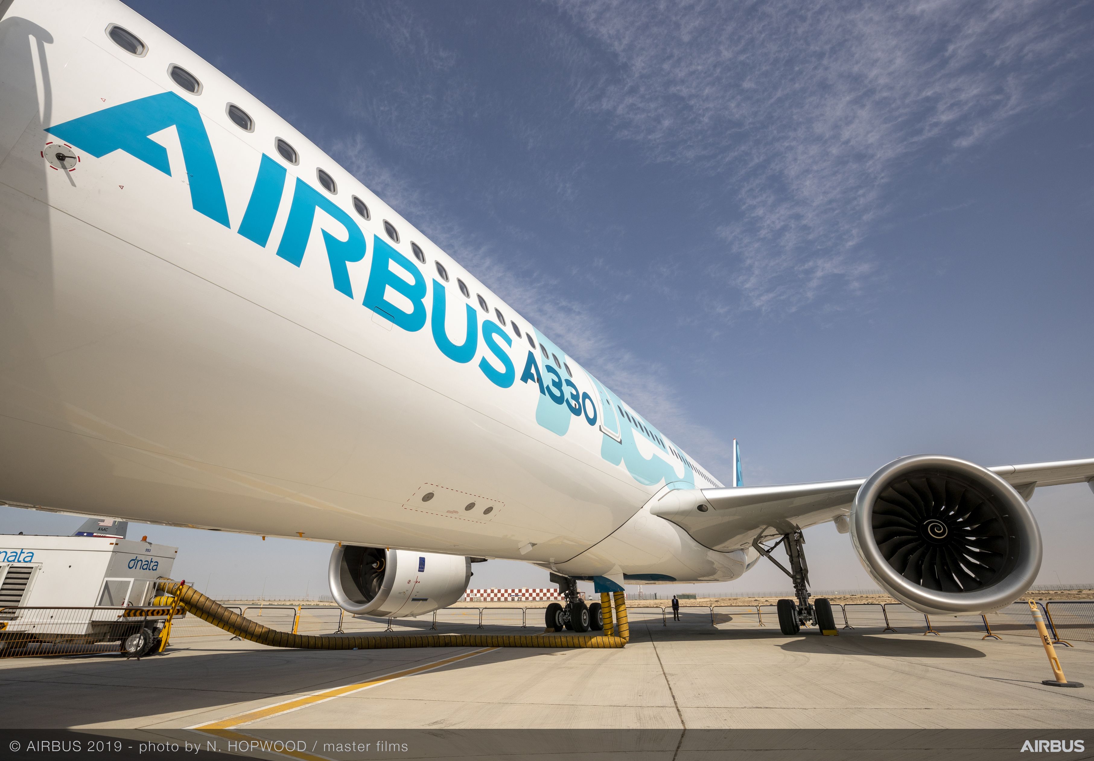 An Airbus A330neo parked on the tarmac.