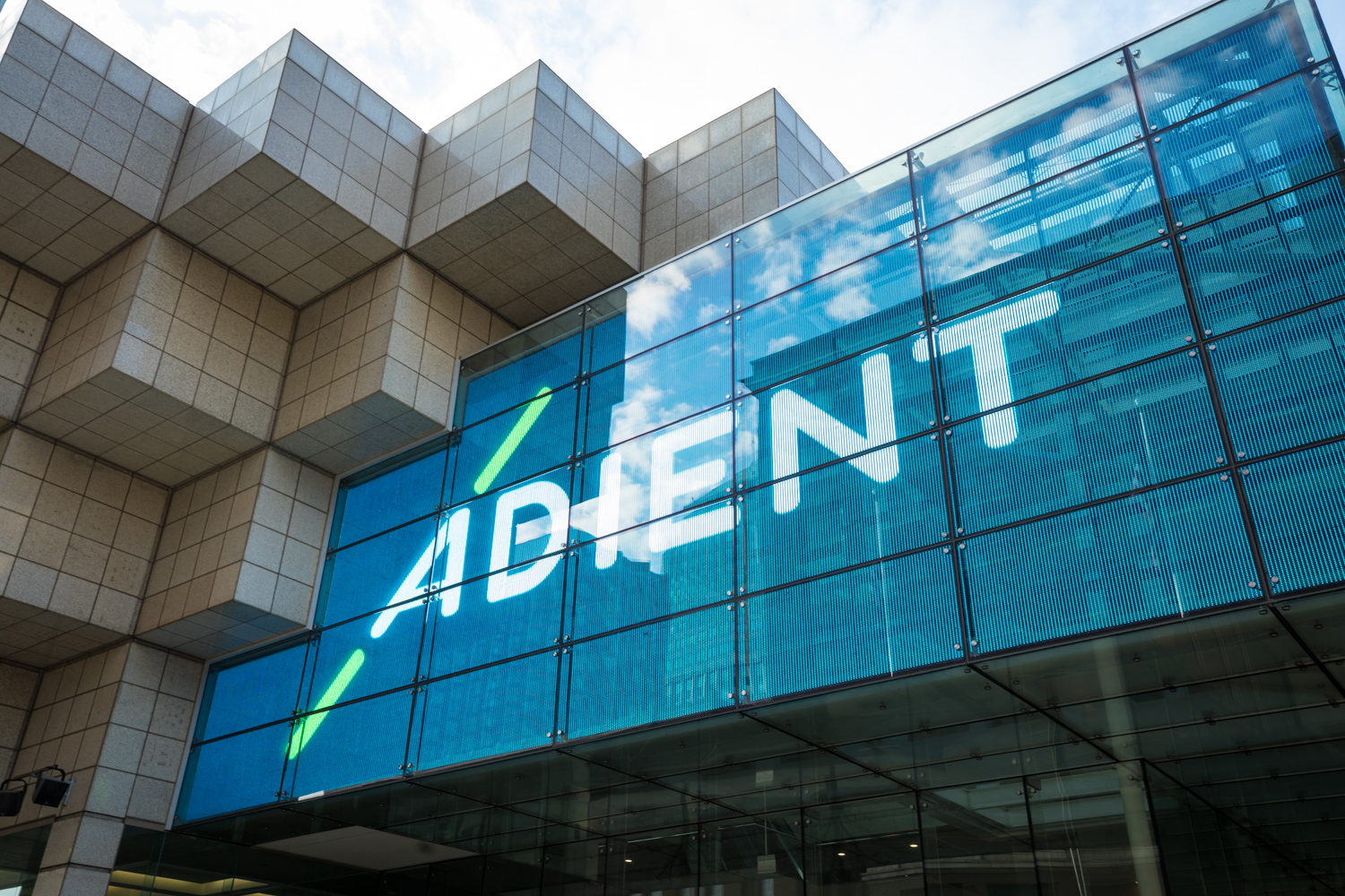 Adient's logo appears on the outside of a convention center in Detroit.