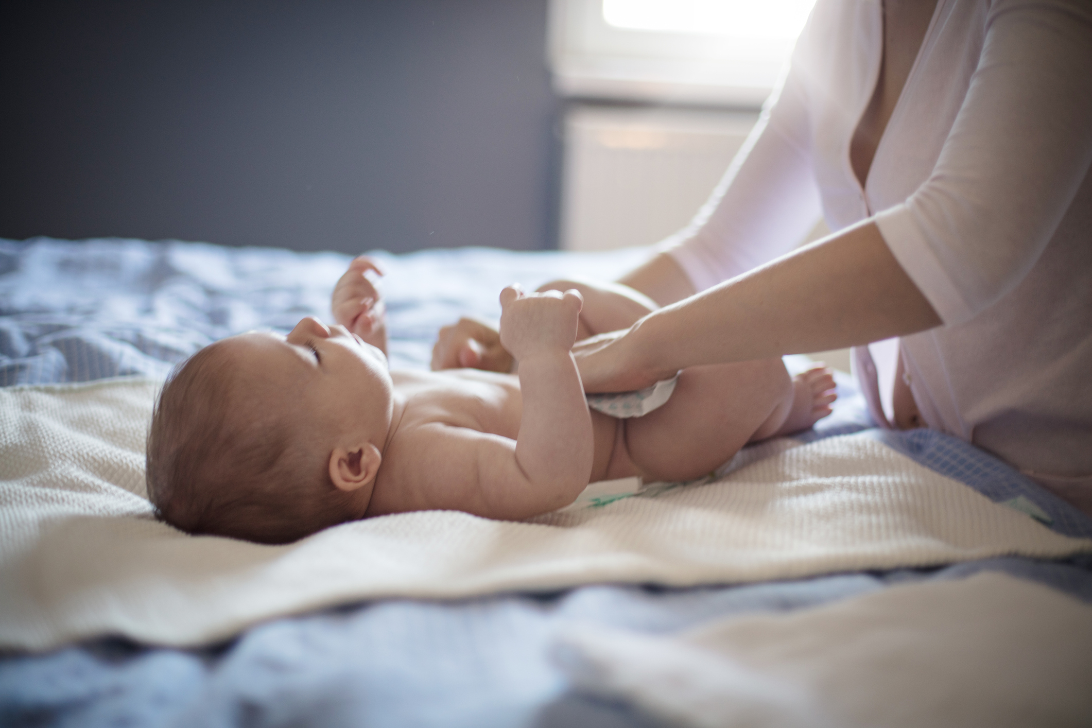 A baby having her diaper changed.