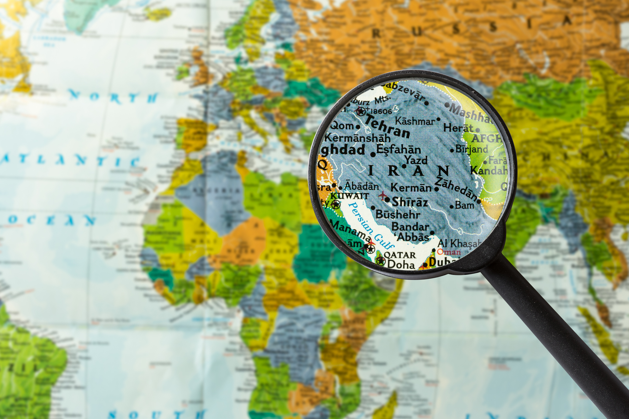 Map of Iran under a magnifying glass