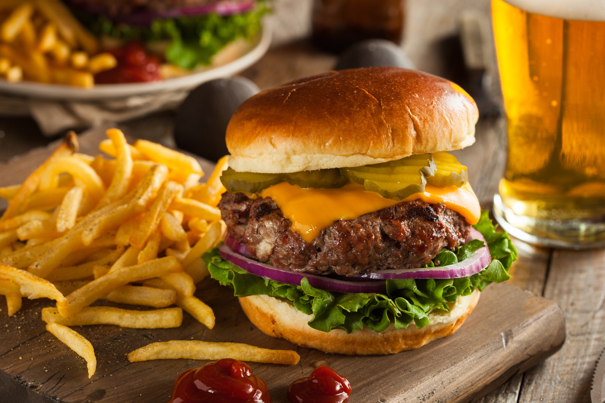 A cheeseburger, fries, and a beer.