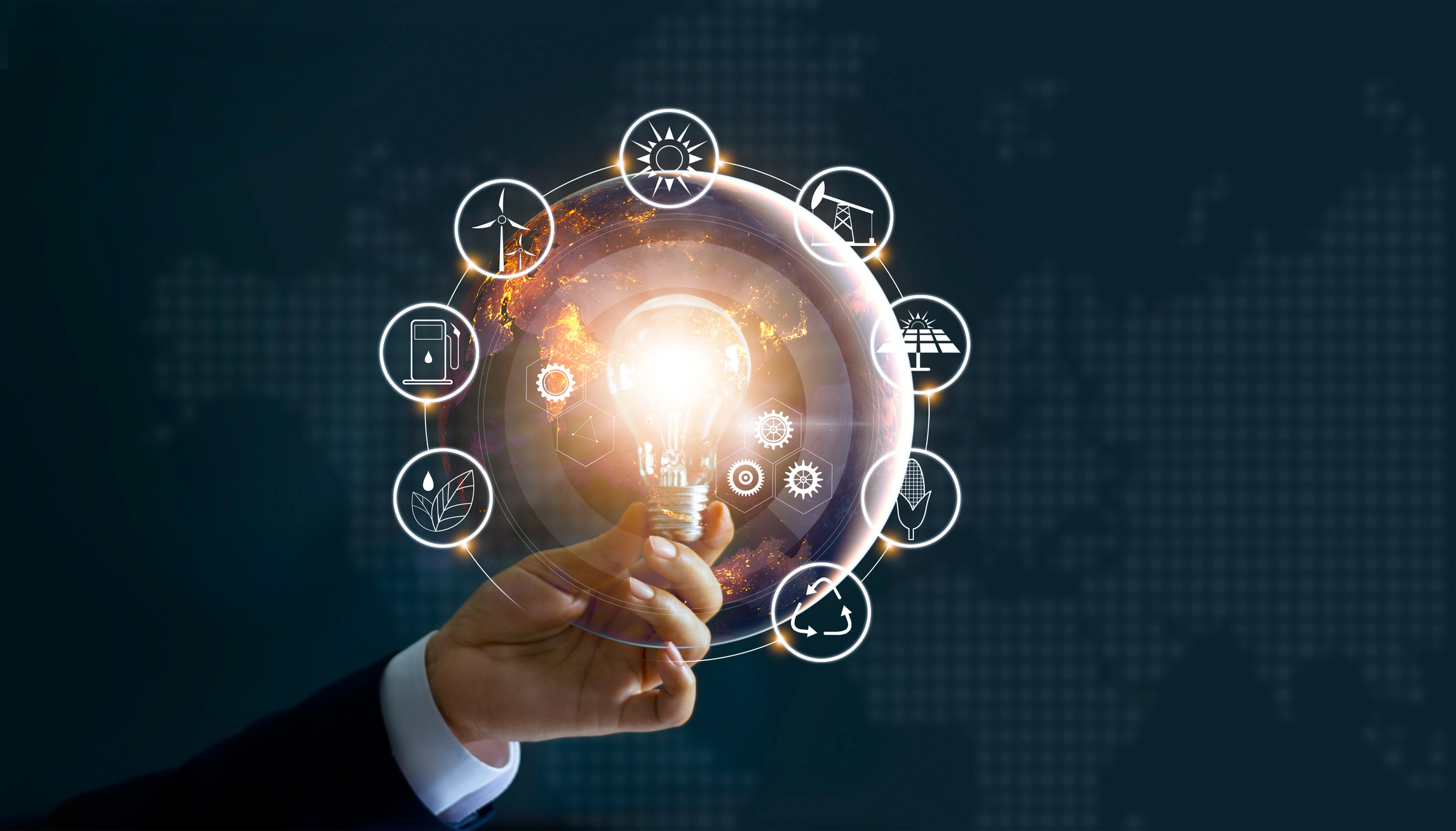 A man's hand holds a lit light bulb surrounded by energy icons