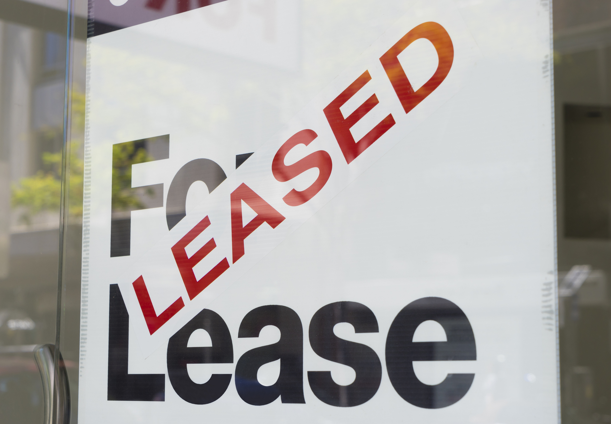 Leased sign on the window of a building.