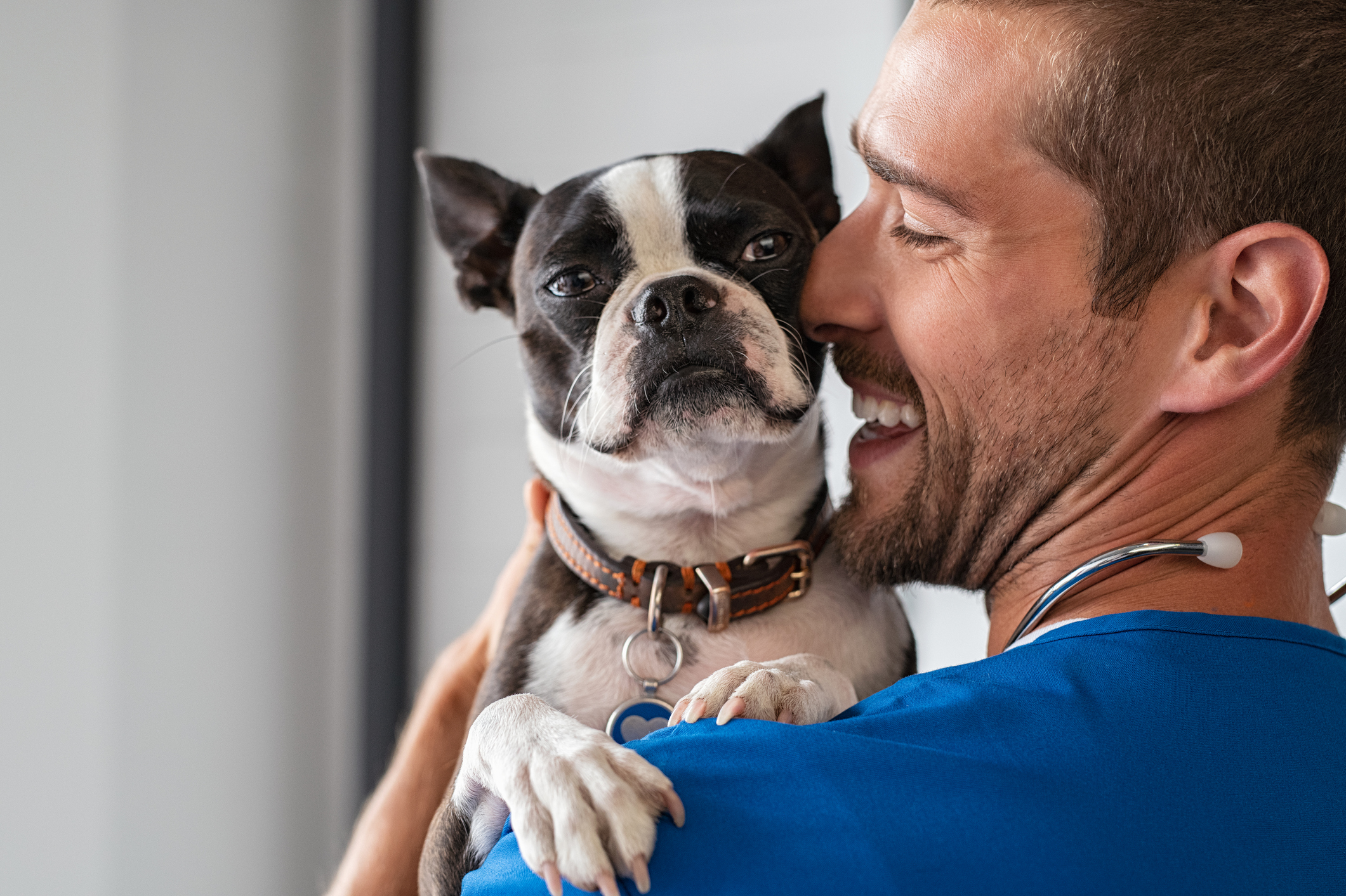 A man is holding a dog.