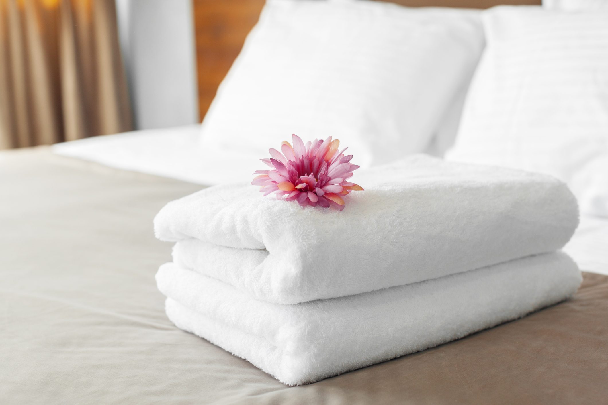 Towels laid out on a hotel bed.