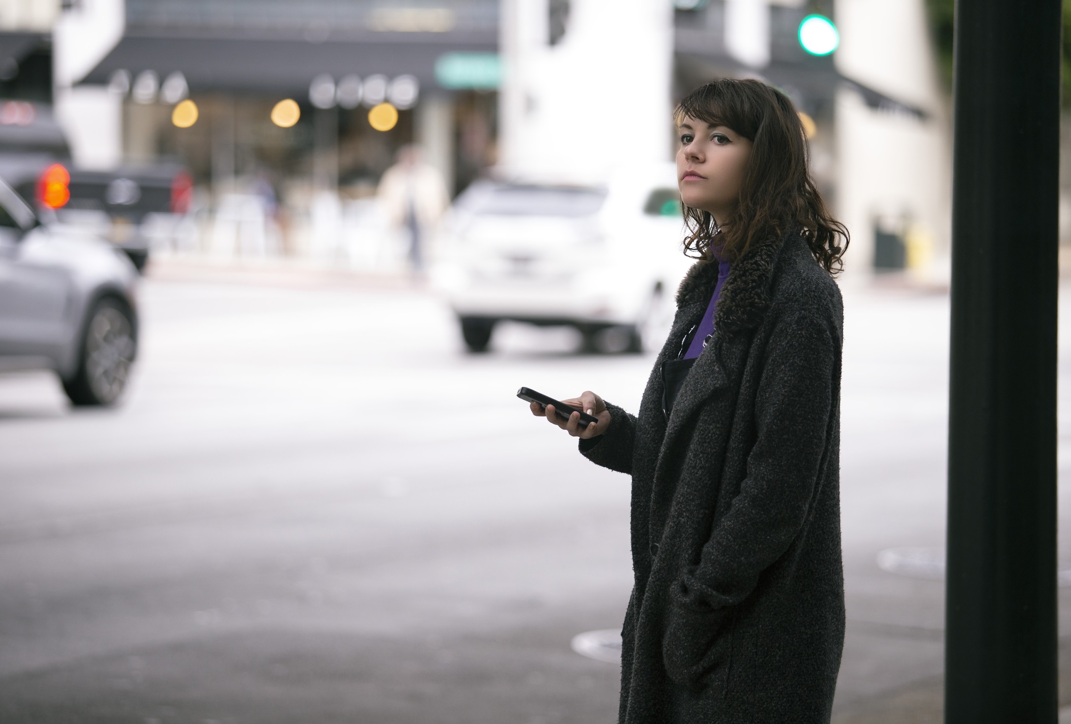 A woman waiting for a rideshare.