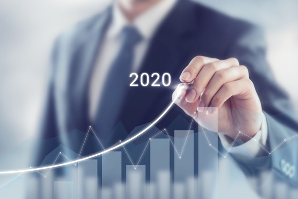 Businessman drawing a chart of growing success in 2020.