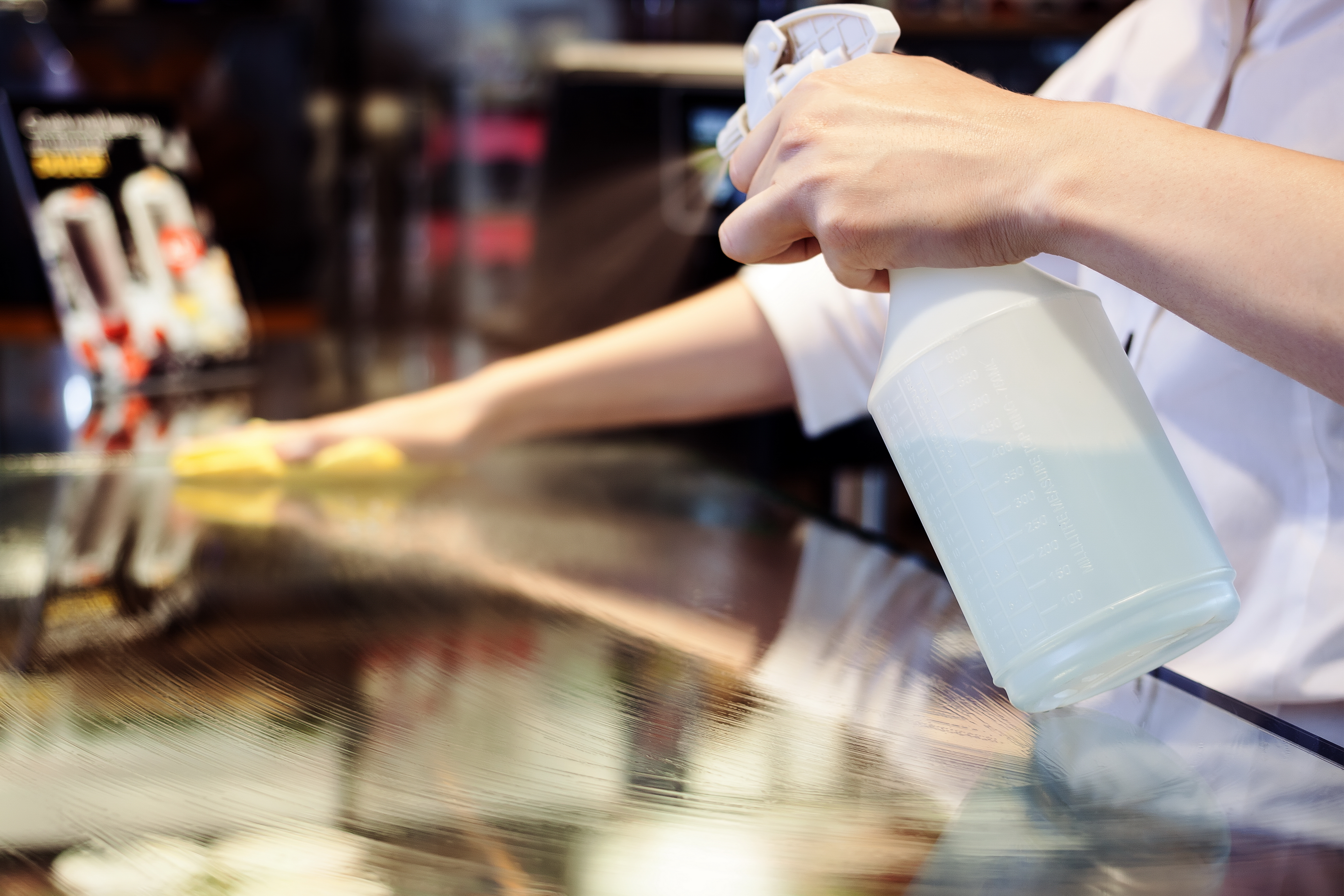 Sanitizing a table or countertop.