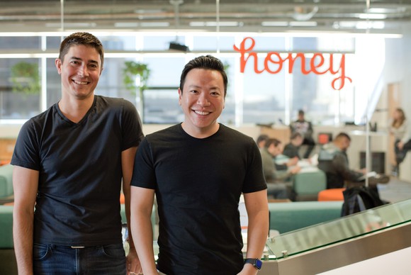 The two founders of Honey standing in their office