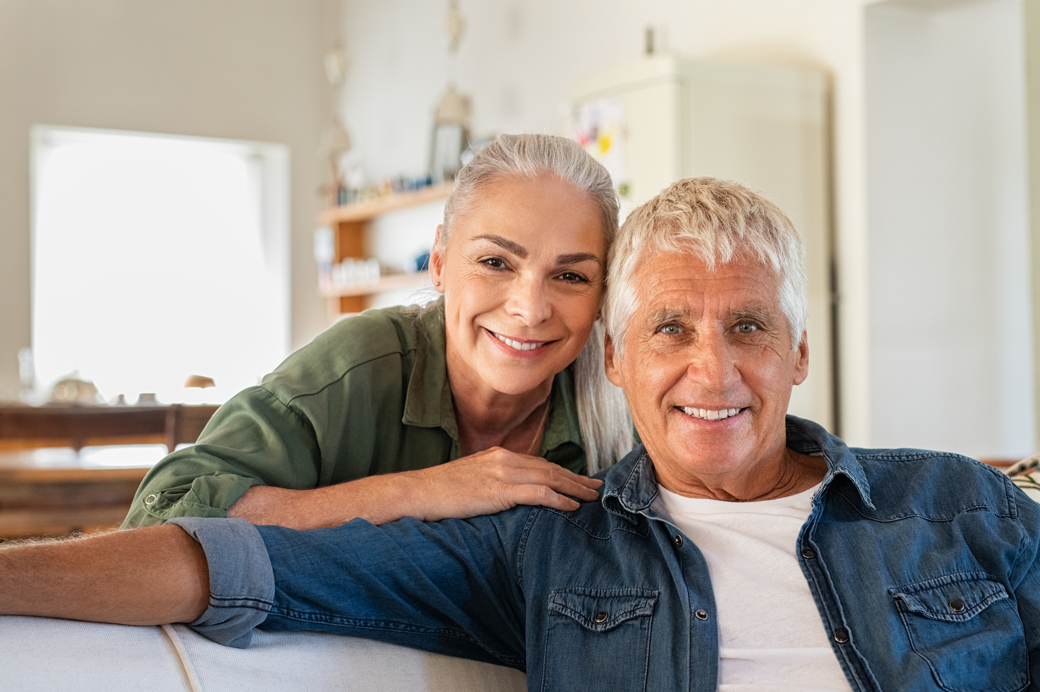 A smiling older couple in their home