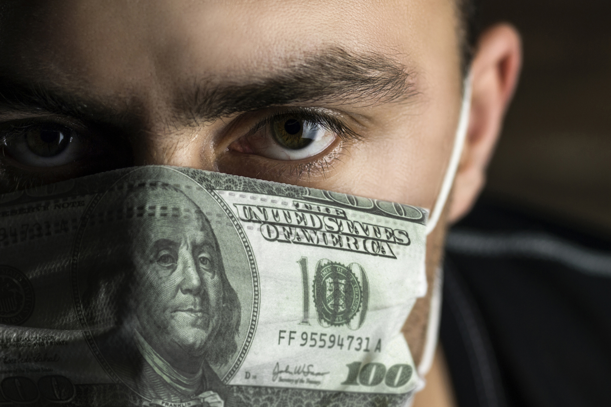 Man wearing mask that looks like a $100 bill