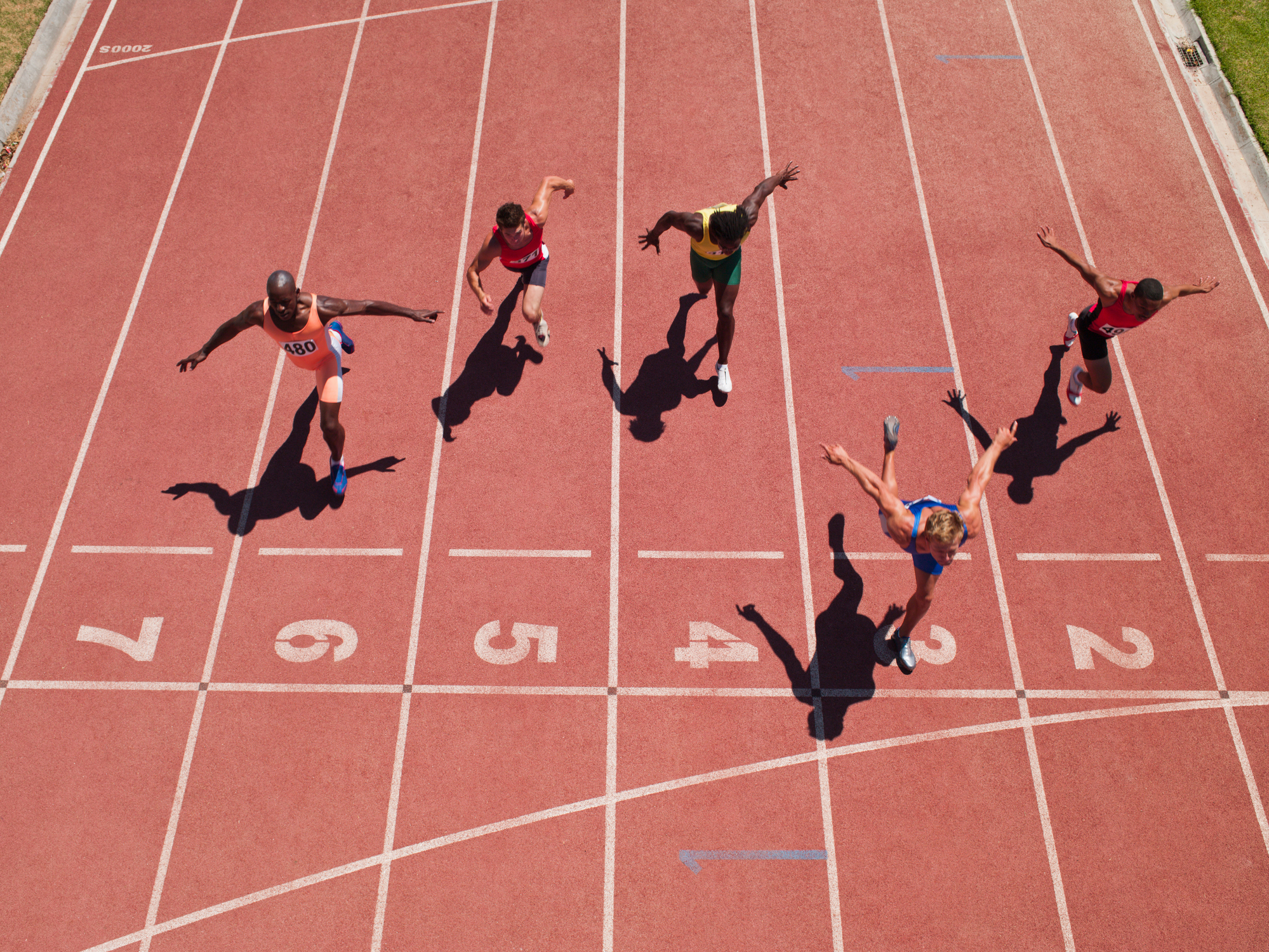 Runners crossing the finish line of a foot race.