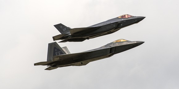 Two Lockheed Martin fighters flying in formation.