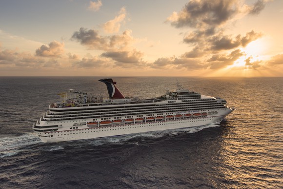 Carnival cruise ship sailing into sunset