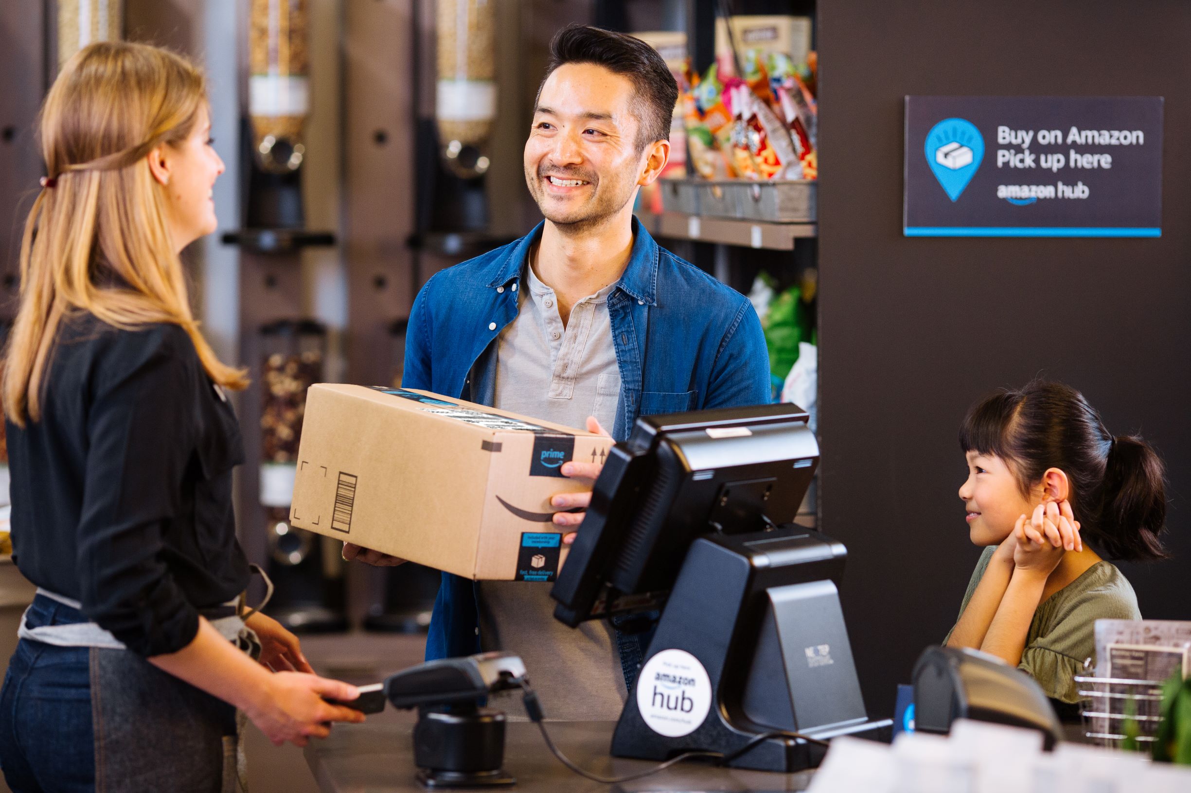 A customer picks up an Amazon package from an Amazon Hub.