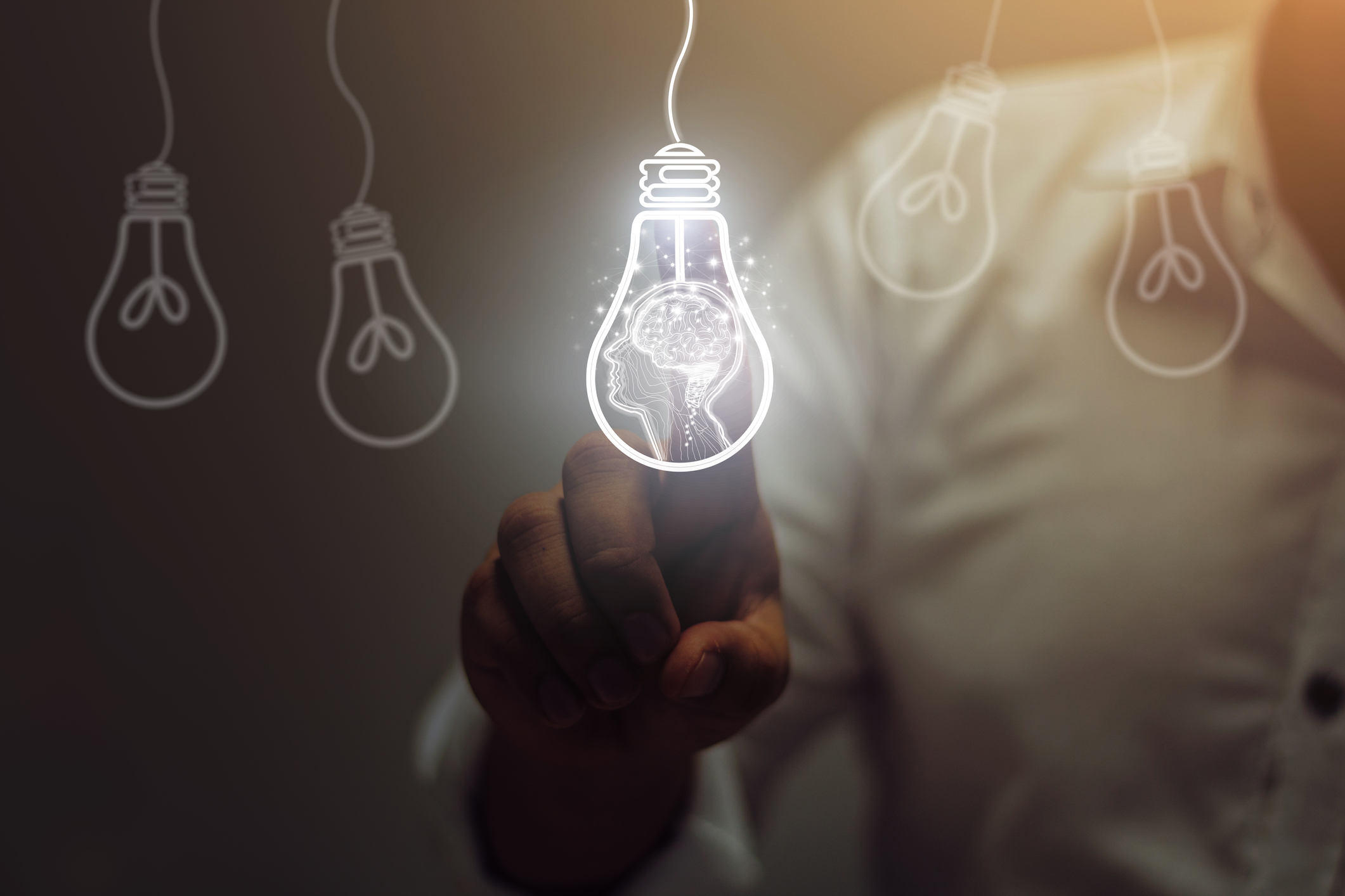 A person pointing at a light bulb