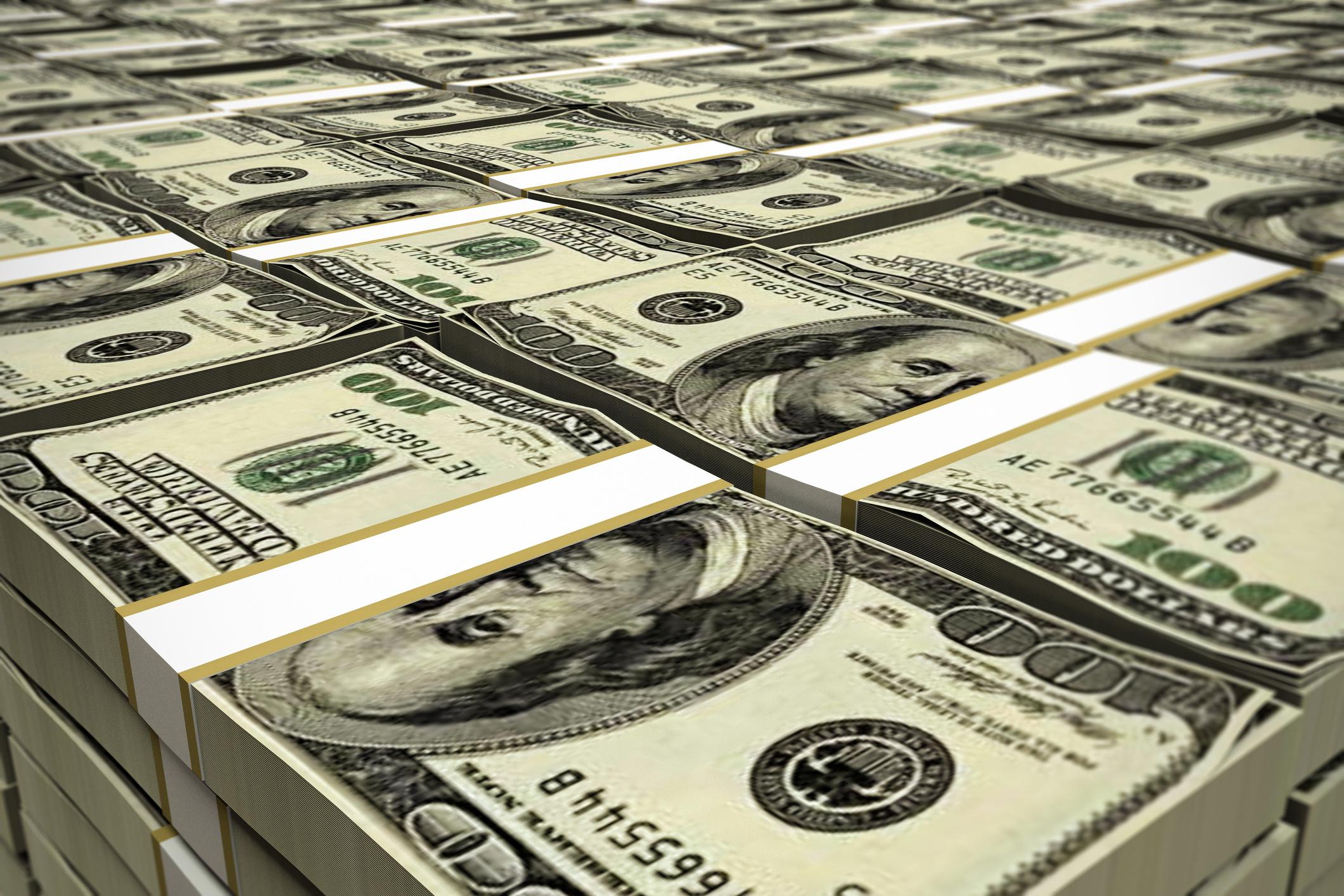 Stacks of hundred dollar bills piled together.