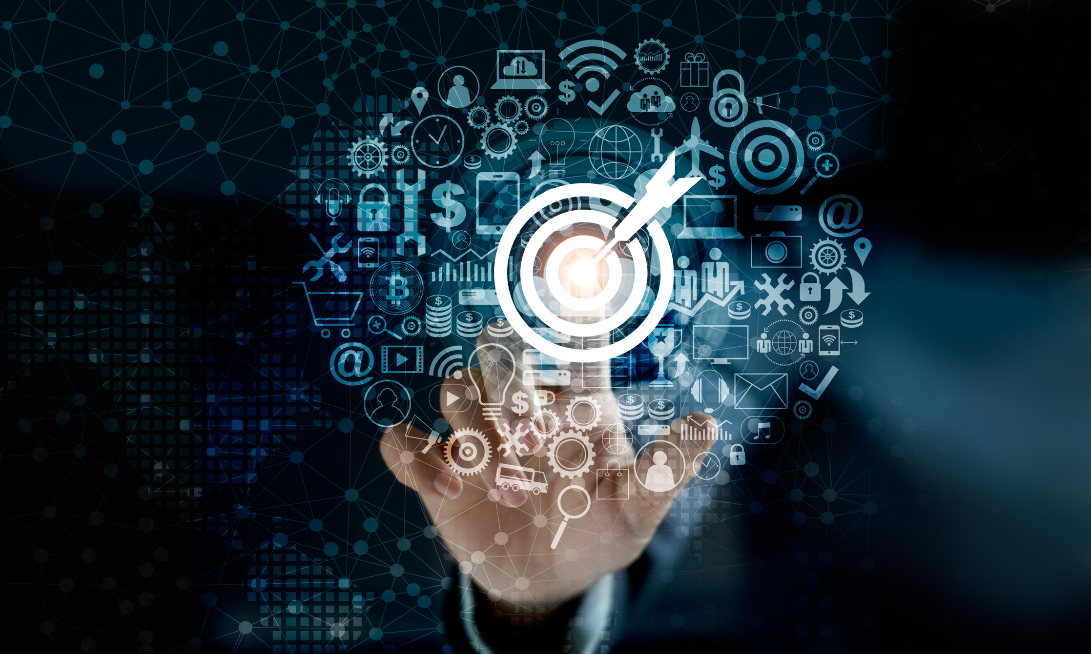 A finger touches the bullseye on a transparent touchscreen.