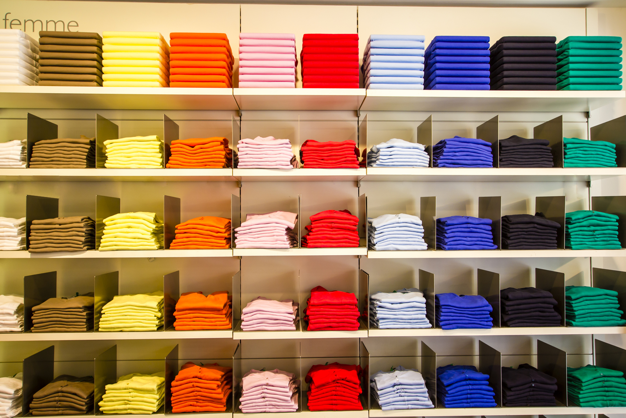 Apparel store's inventory of well-folded shirts on shelves