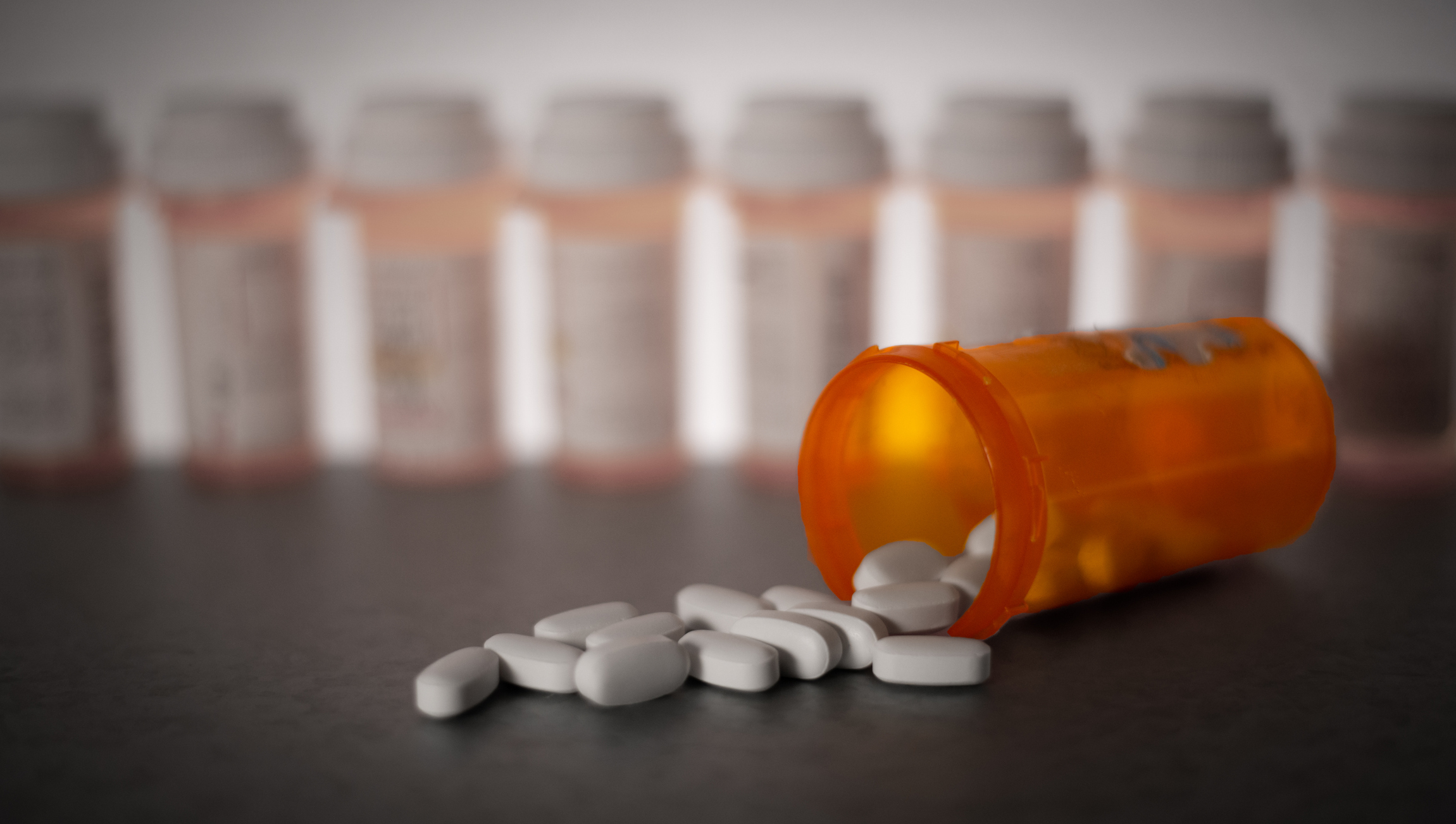 Pills spilling out of prescription medication bottle