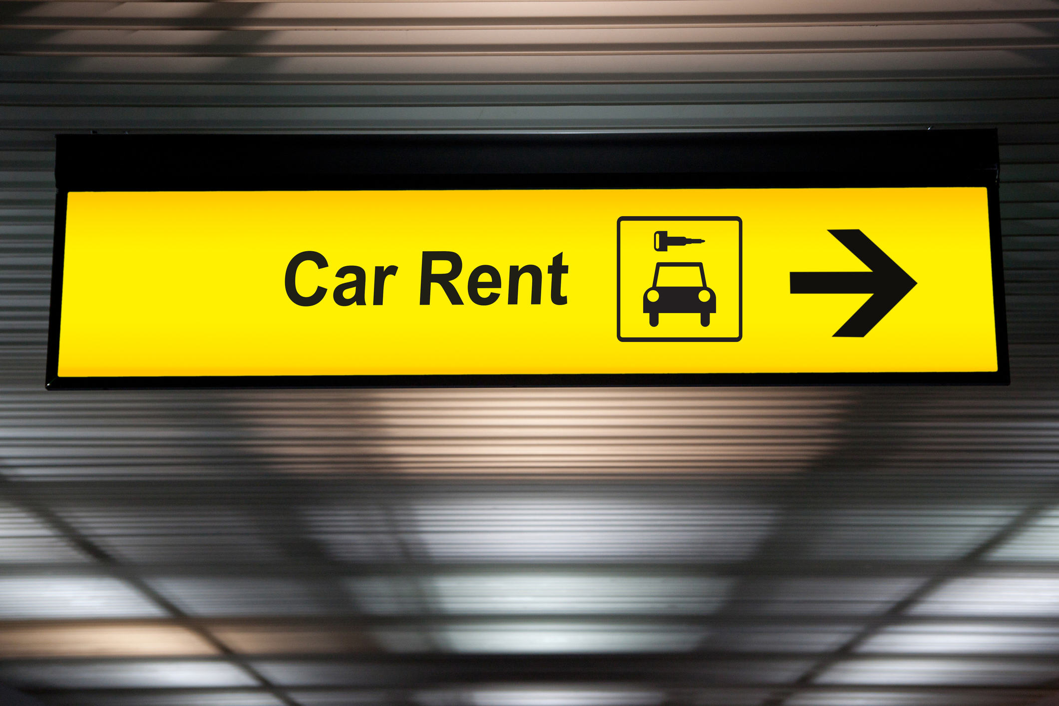 Car rental sign at an airport.