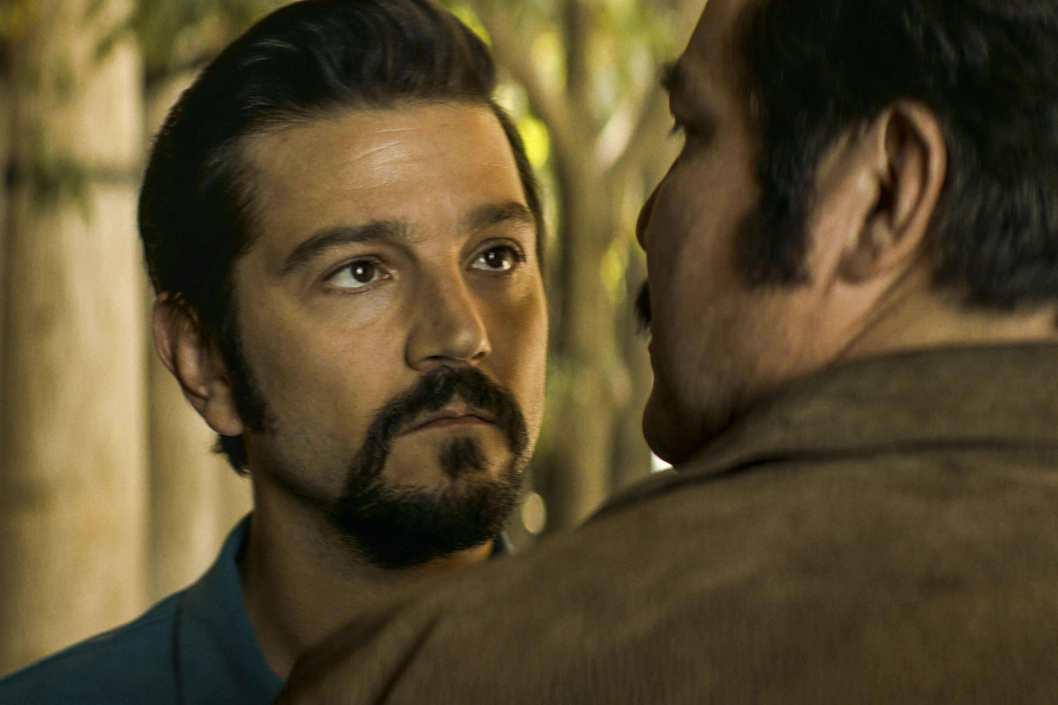 A man staring intently at another man.
