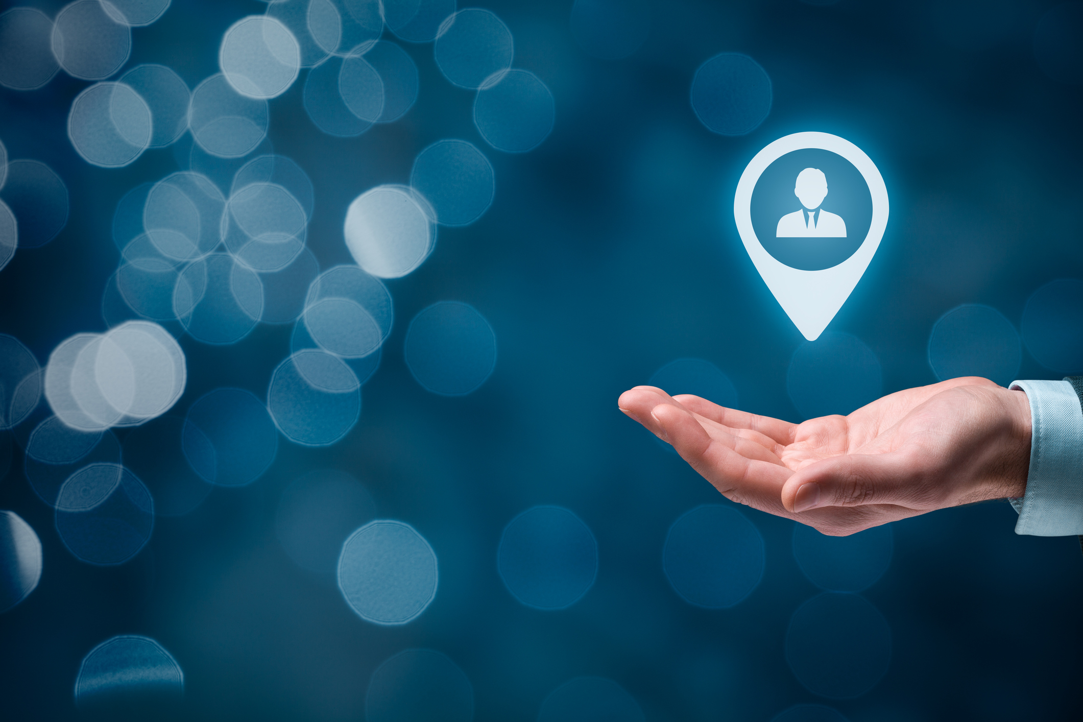 Man's hand under a digital targeted customer symbol.