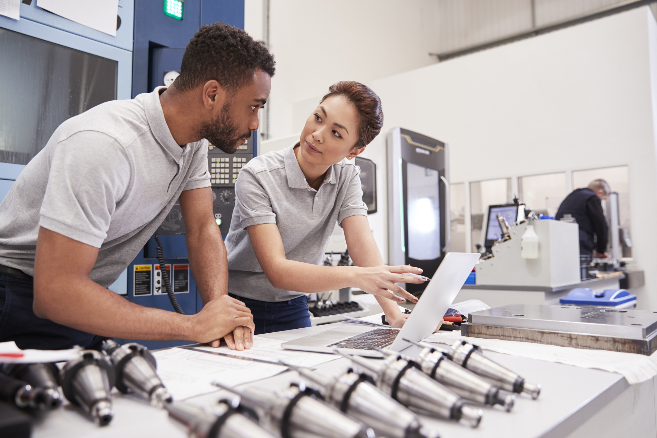 Factory engineers utilizing data center technology for machines.